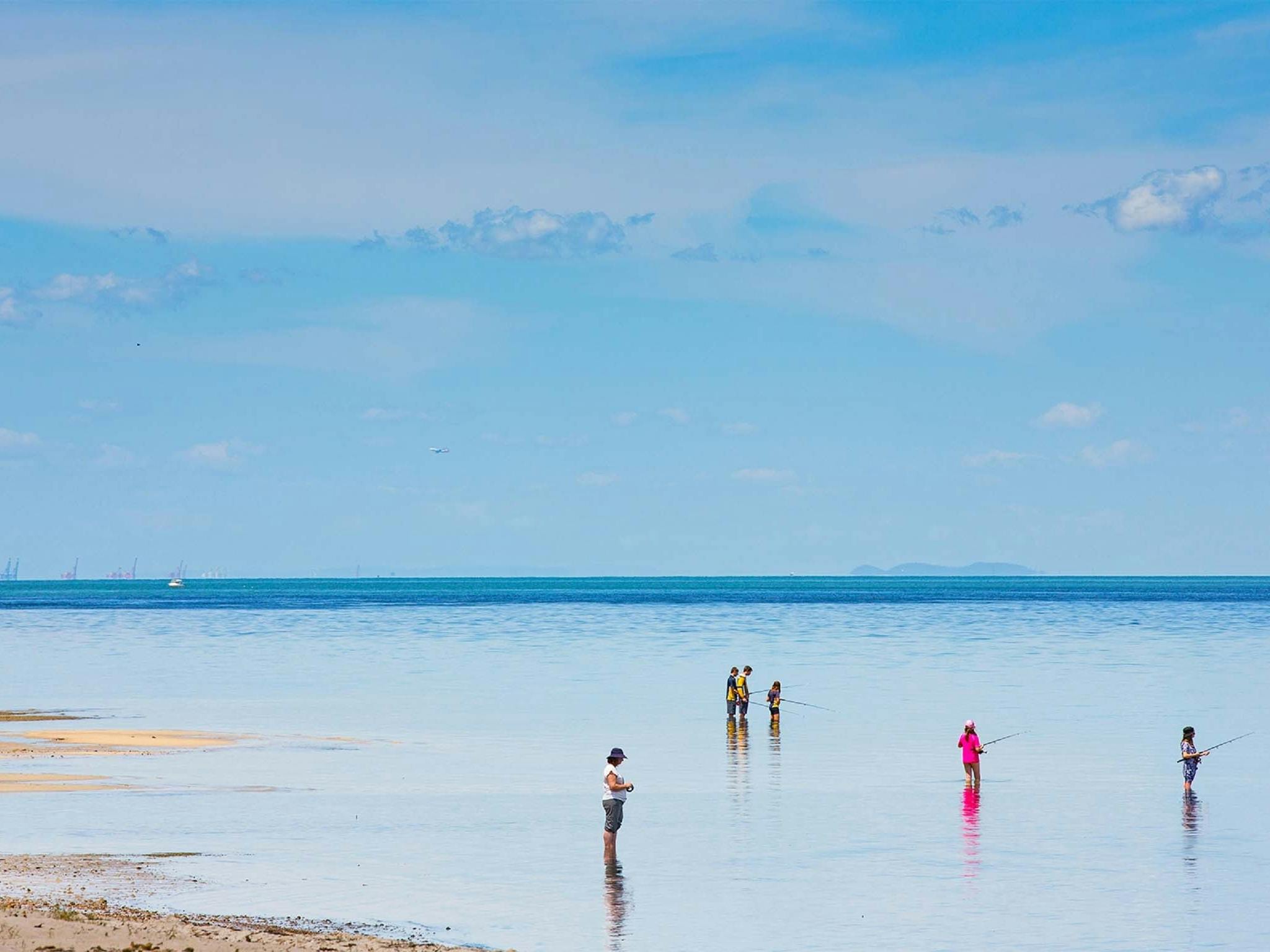 A number of people fishing at Bongaree Beach, Bribie Island