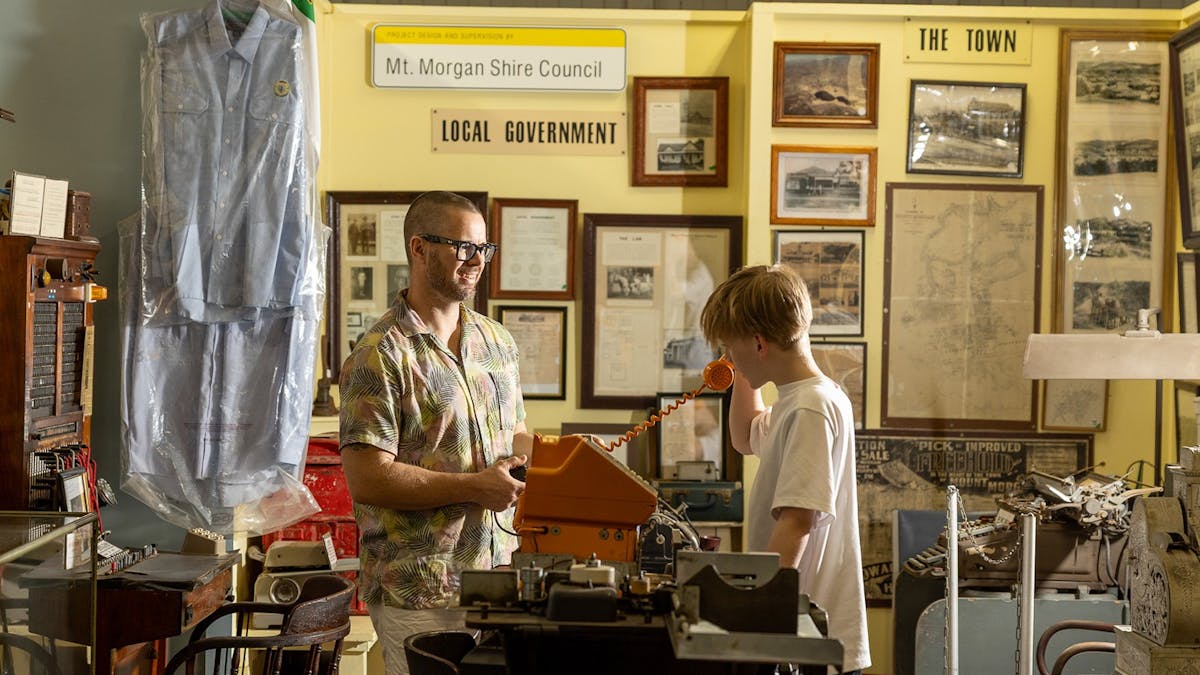 Two men looking at historical relics at the Mount Morgan historical Museum.