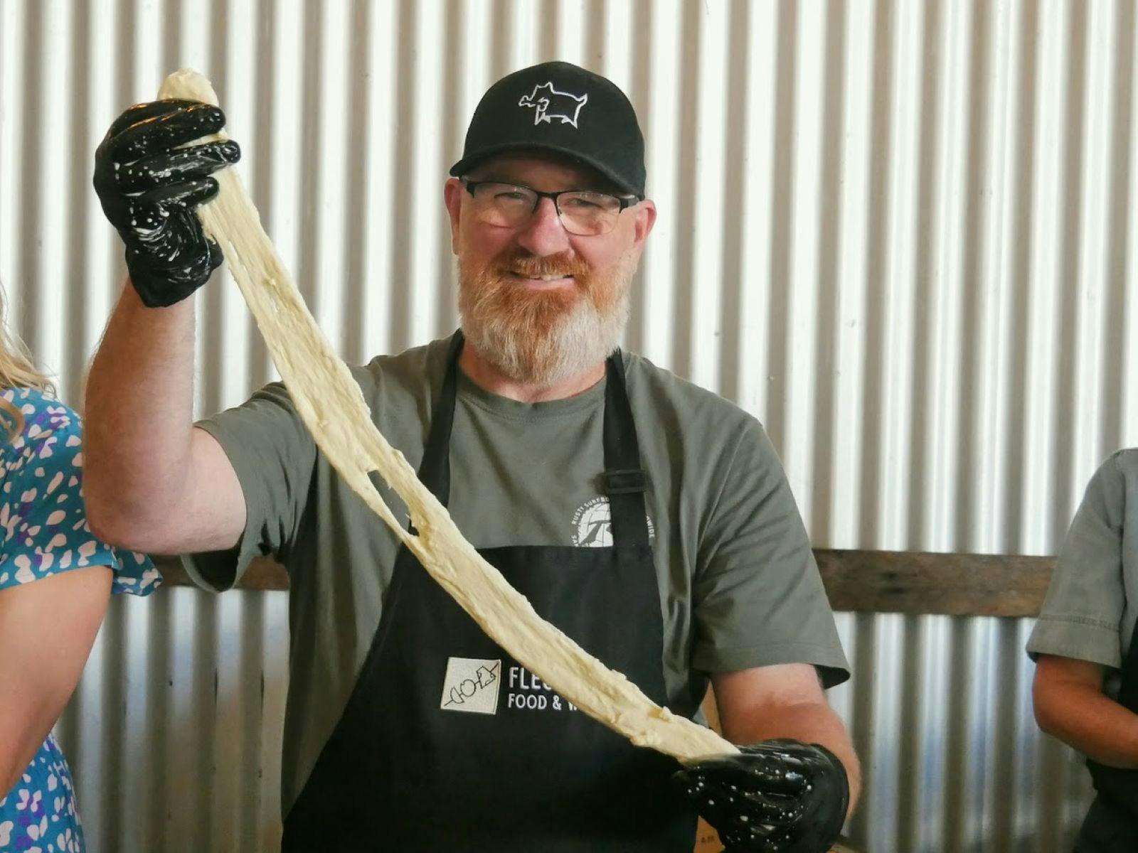 Older Man Stretching Mozzarella