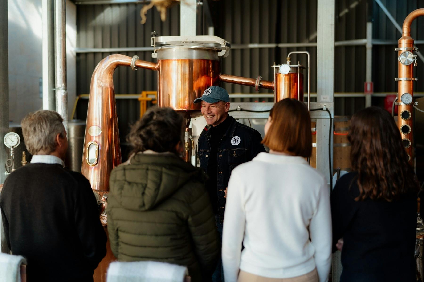 Hank the distiller speaks to a small tour group inside Swiftcrest Distillery