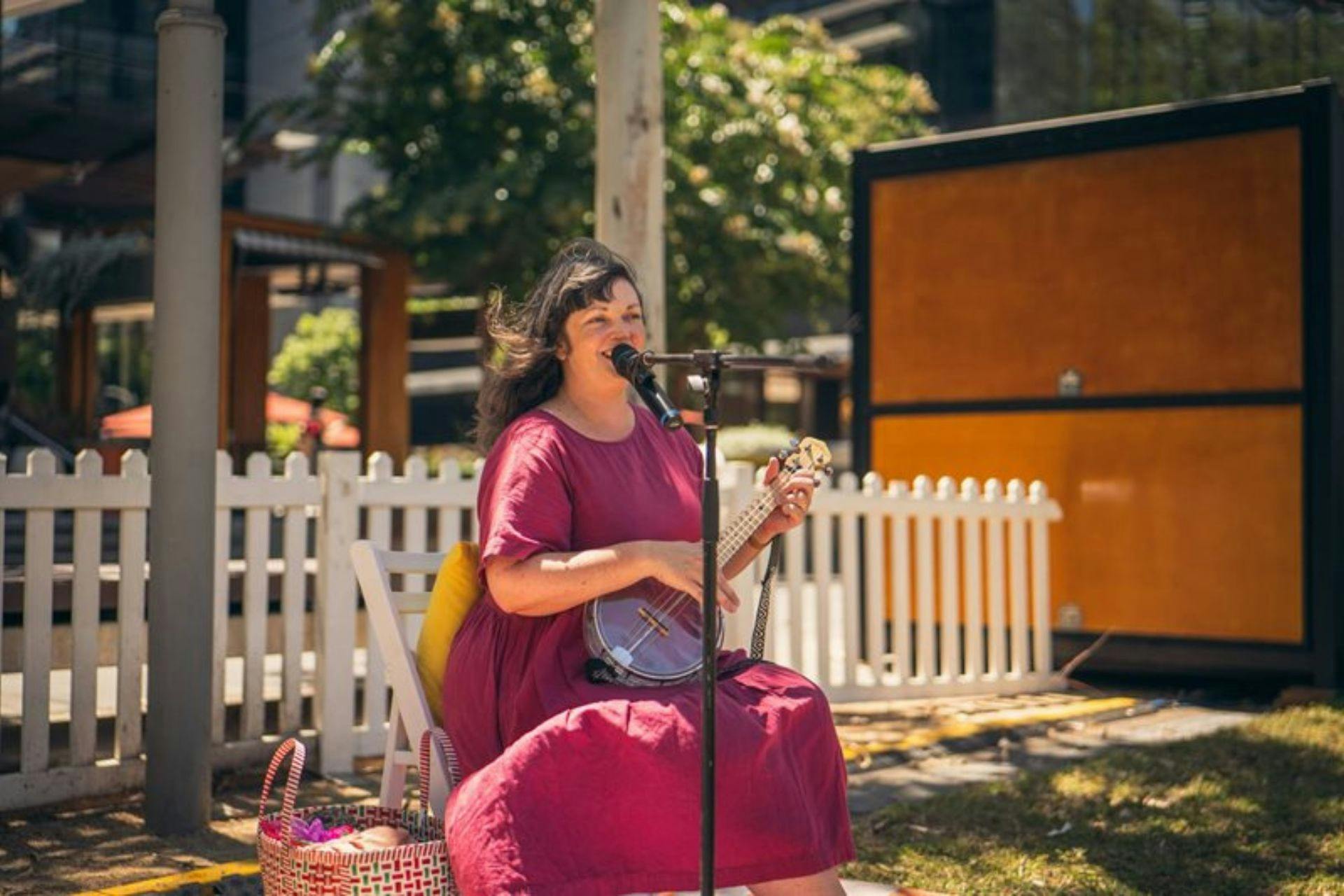 Lady singing and playing guitar