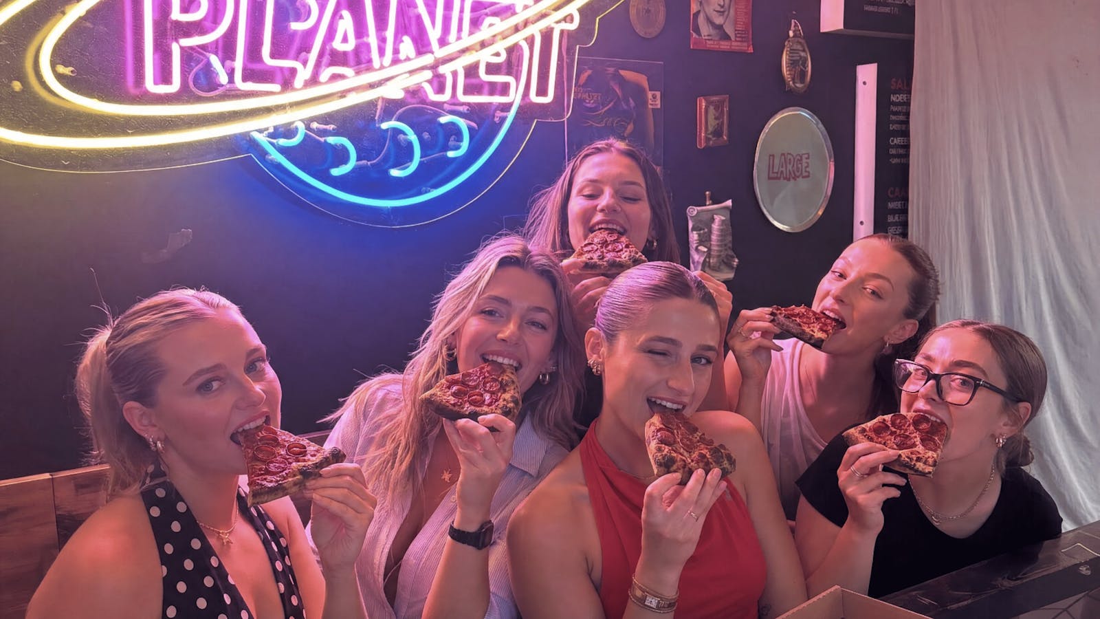 Sharing pizza inside Medici Pizzeria