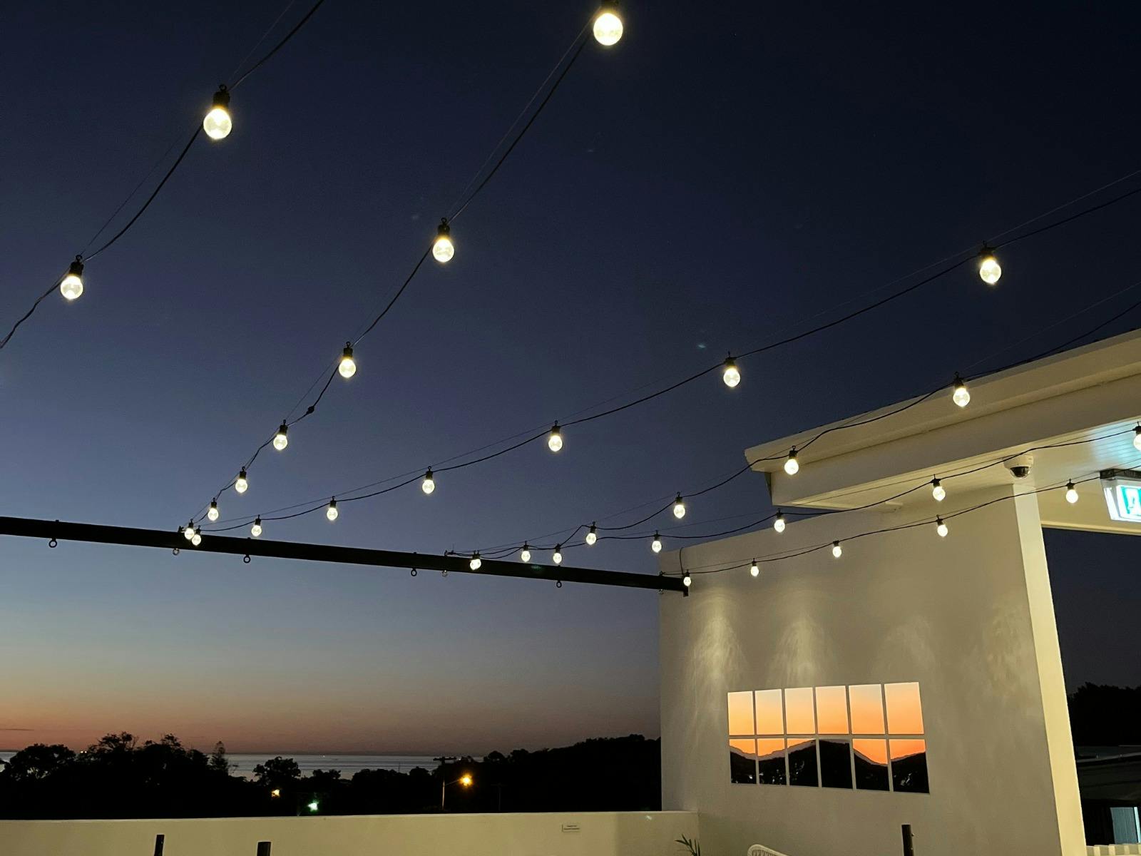 rooftop with festoon lights and night sky