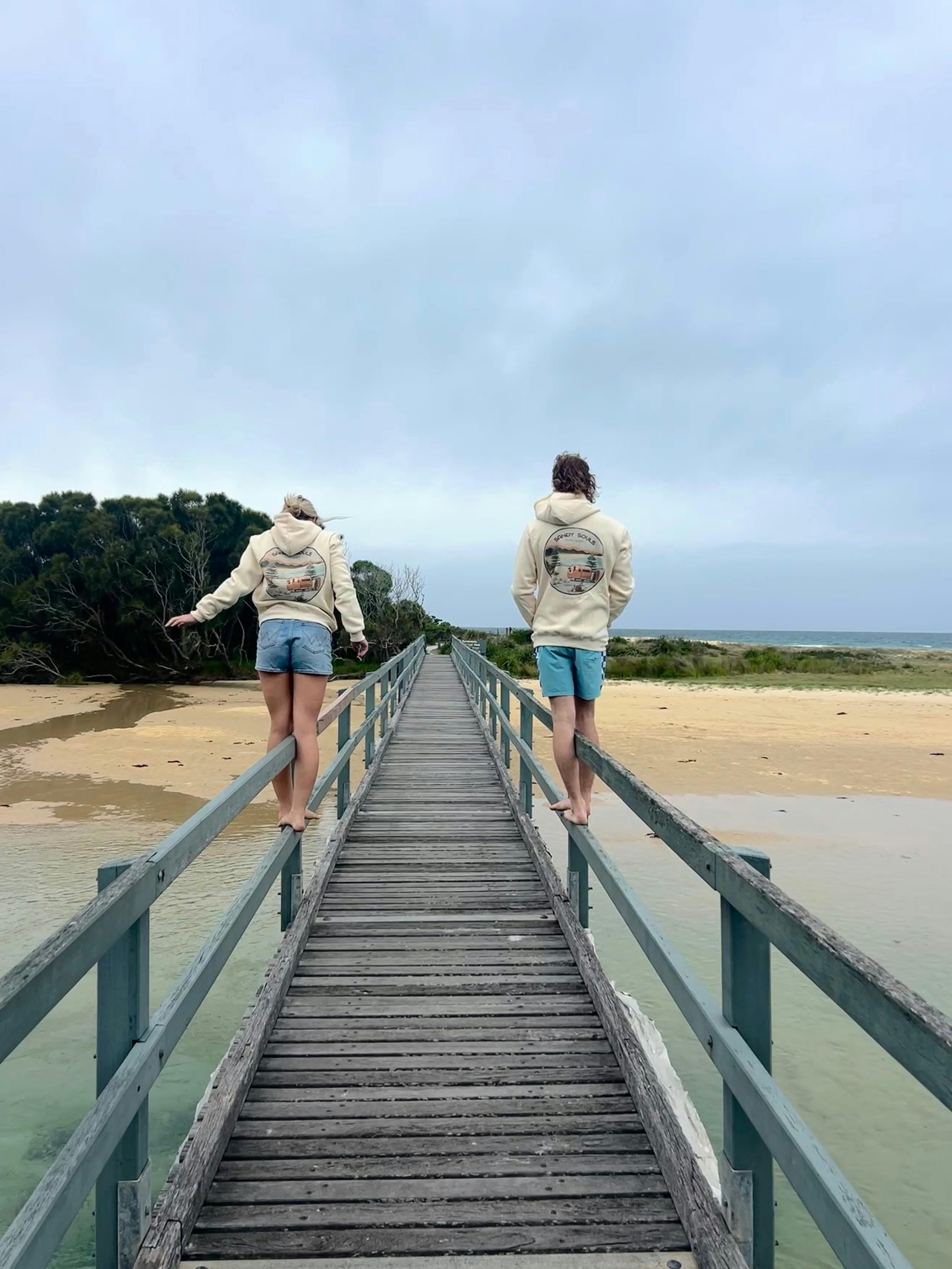 Friends wearing Sandy Souls Dalmeny hoodies at the iconic Dalmeny bridge, NSW