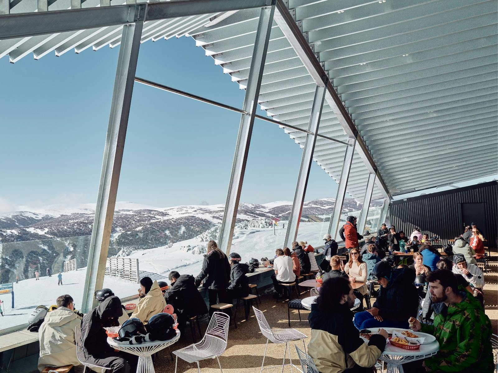 Cloud 9 balcony with mountain views and people enjoying lunch