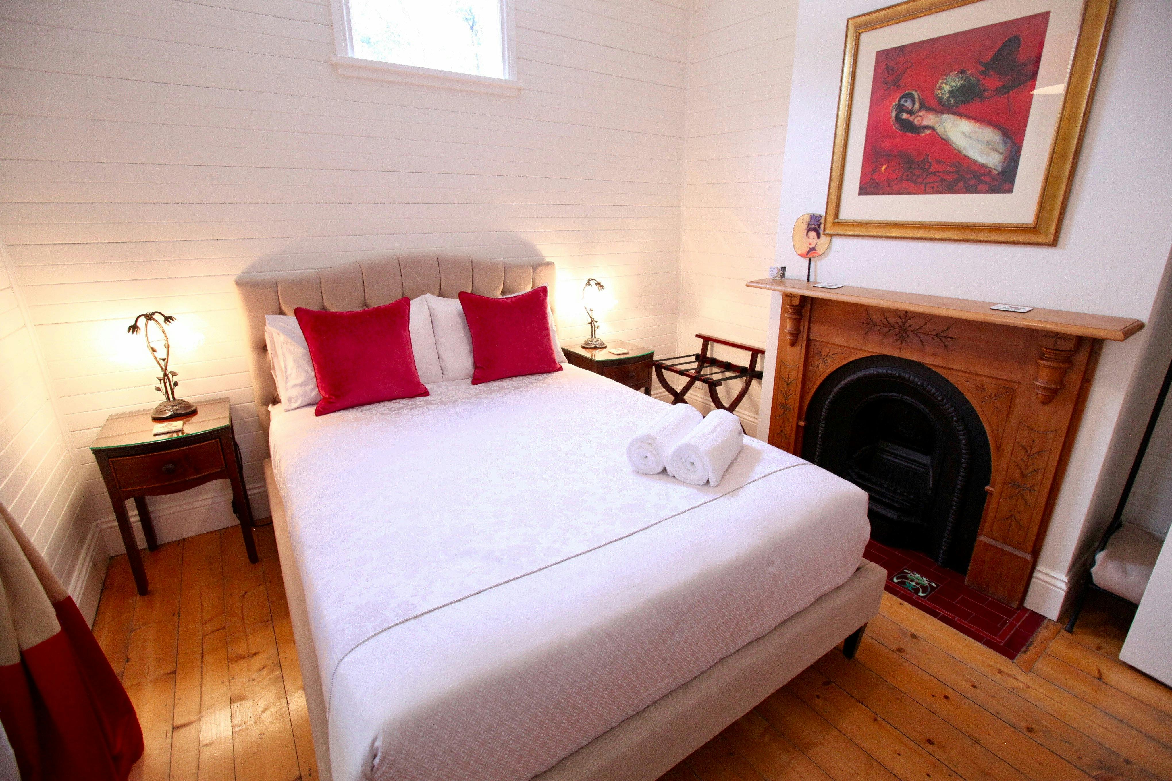 Queen bedroom with original fireplace