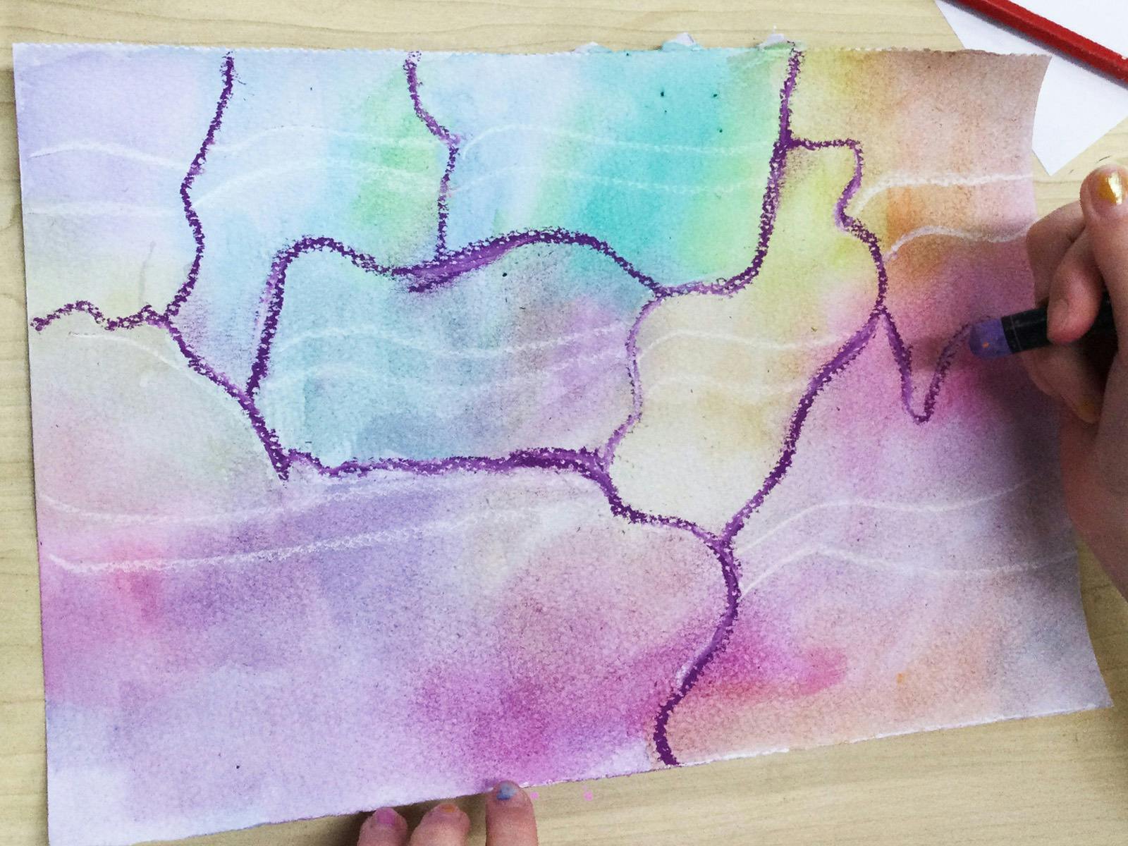 Kids hands working on a watercolour painting