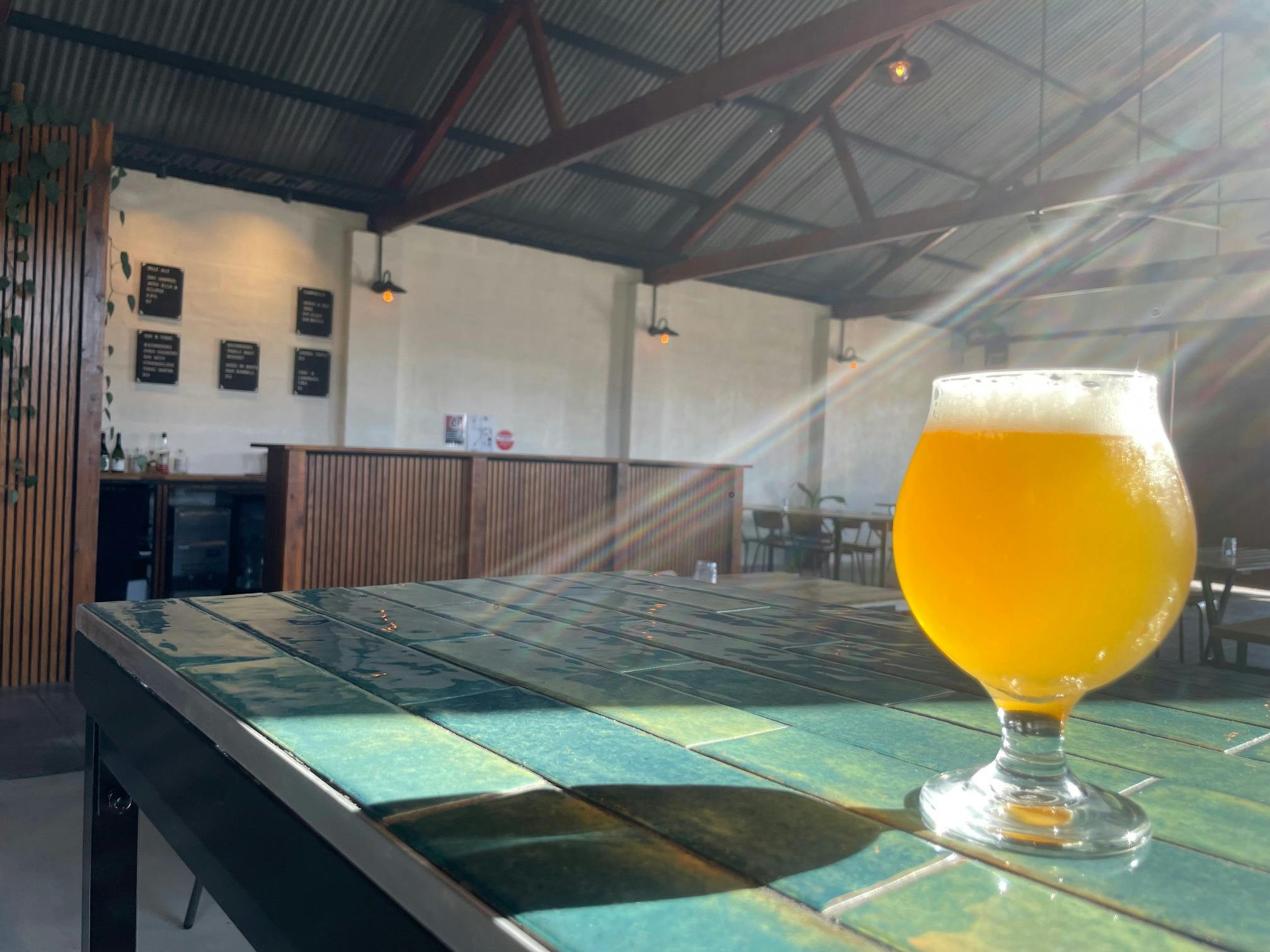 Beer on a table with bar in background