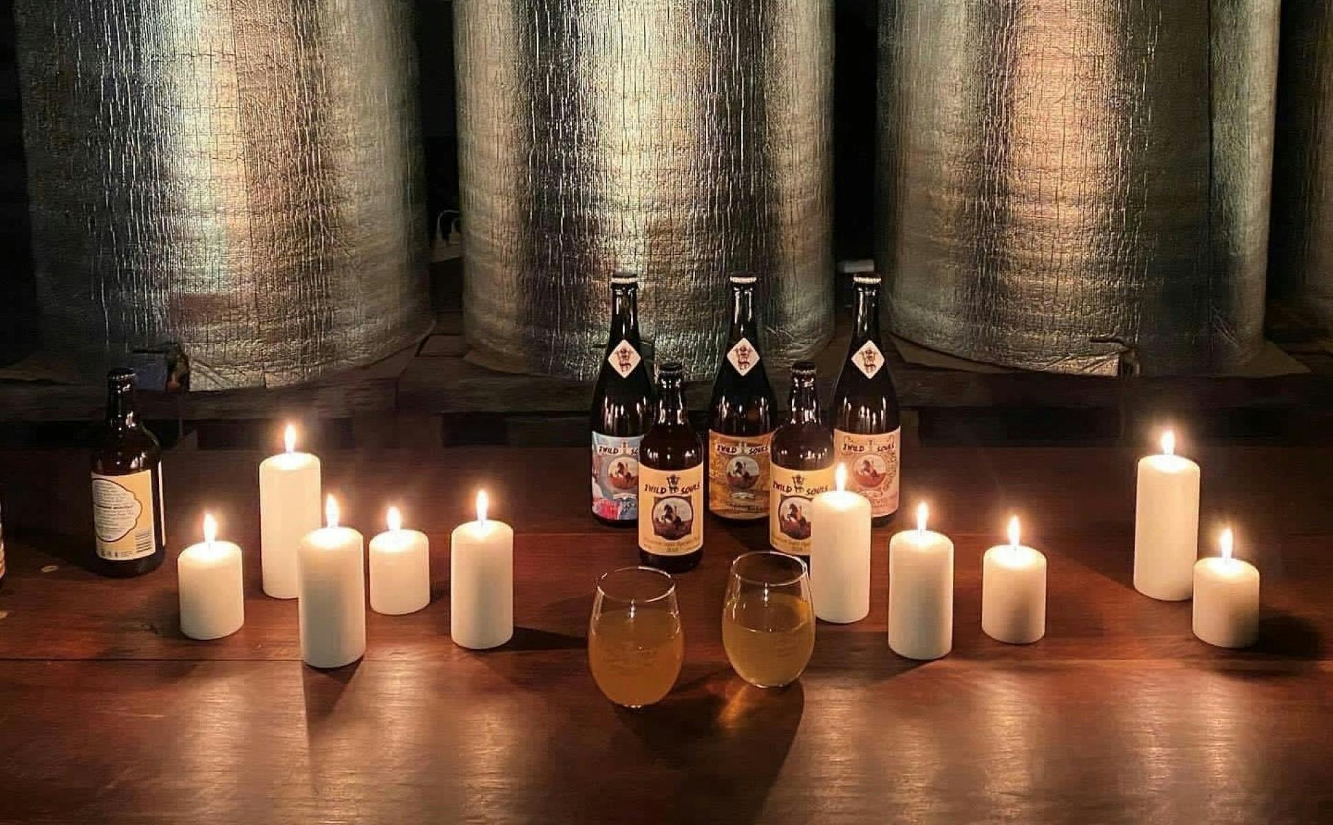 2 Wild Souls Meadery & Distillery with bottles, glasses of Mead and candles