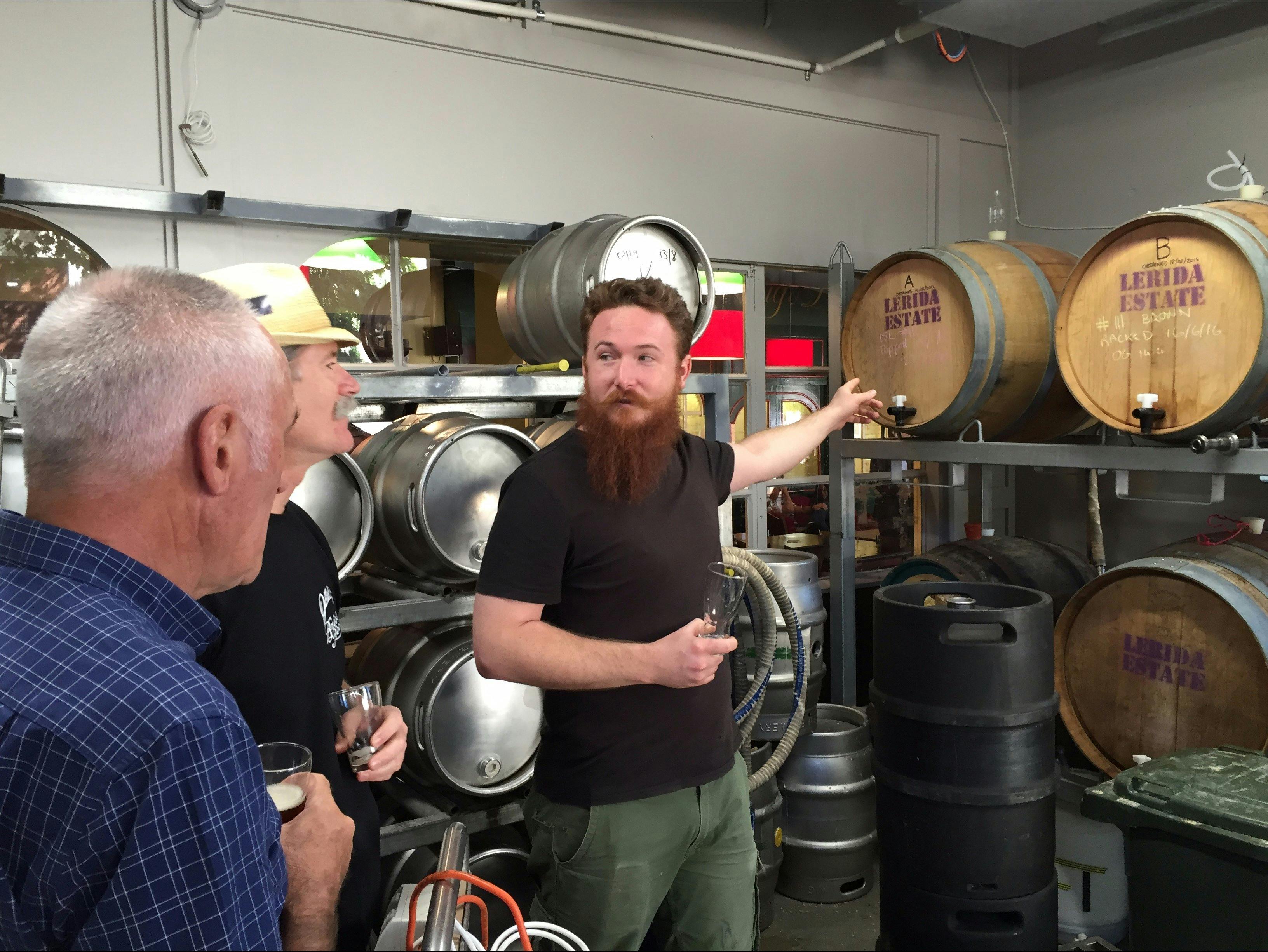 Men in the barrel room at Wig & Pen