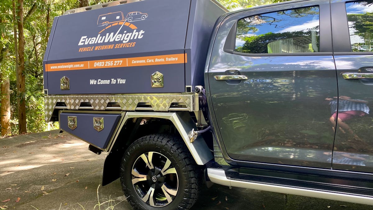 EvaluWeight branded vehicle (grey with white and orange logo)