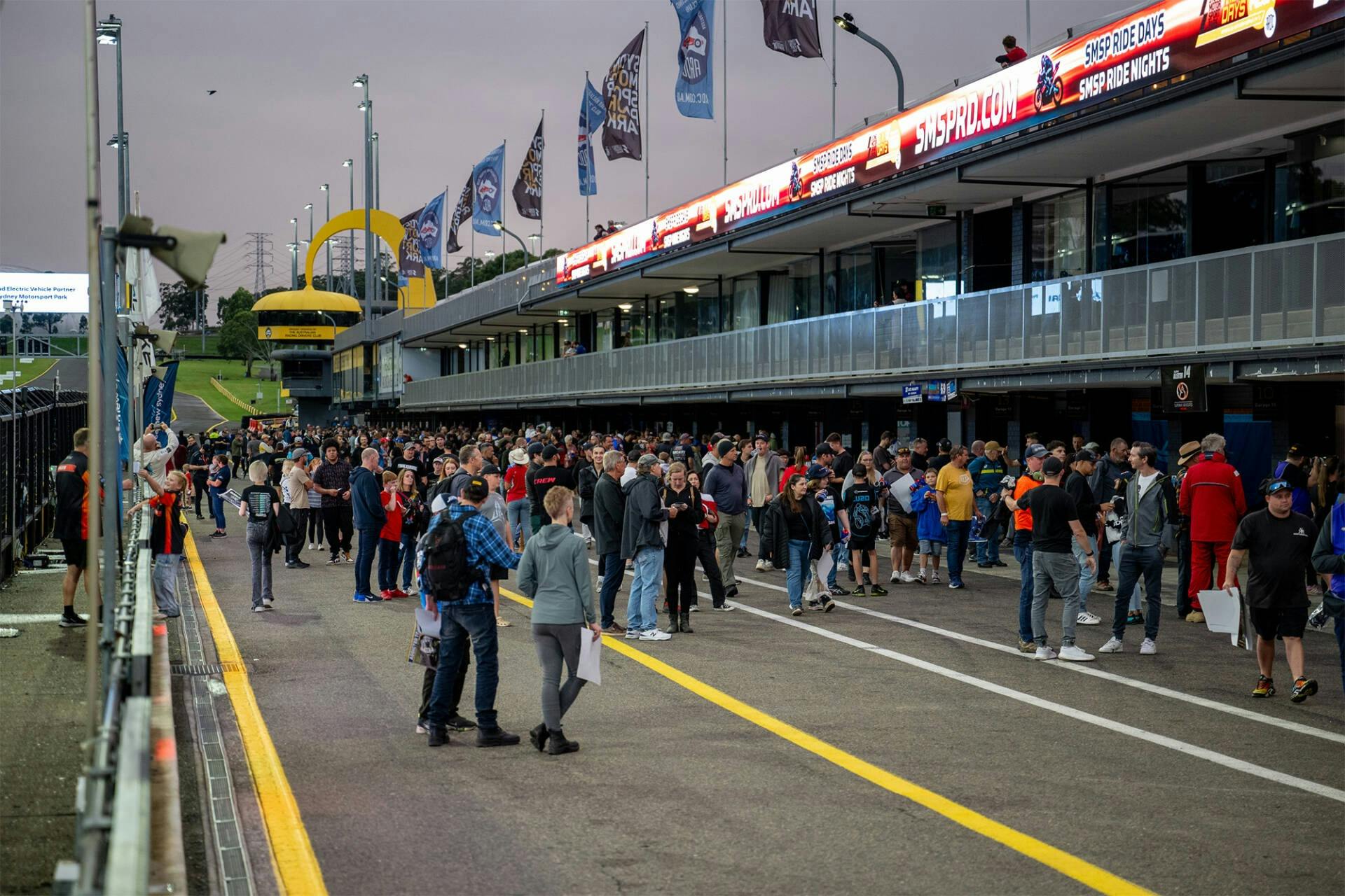 Attendees walking through the open pitlane