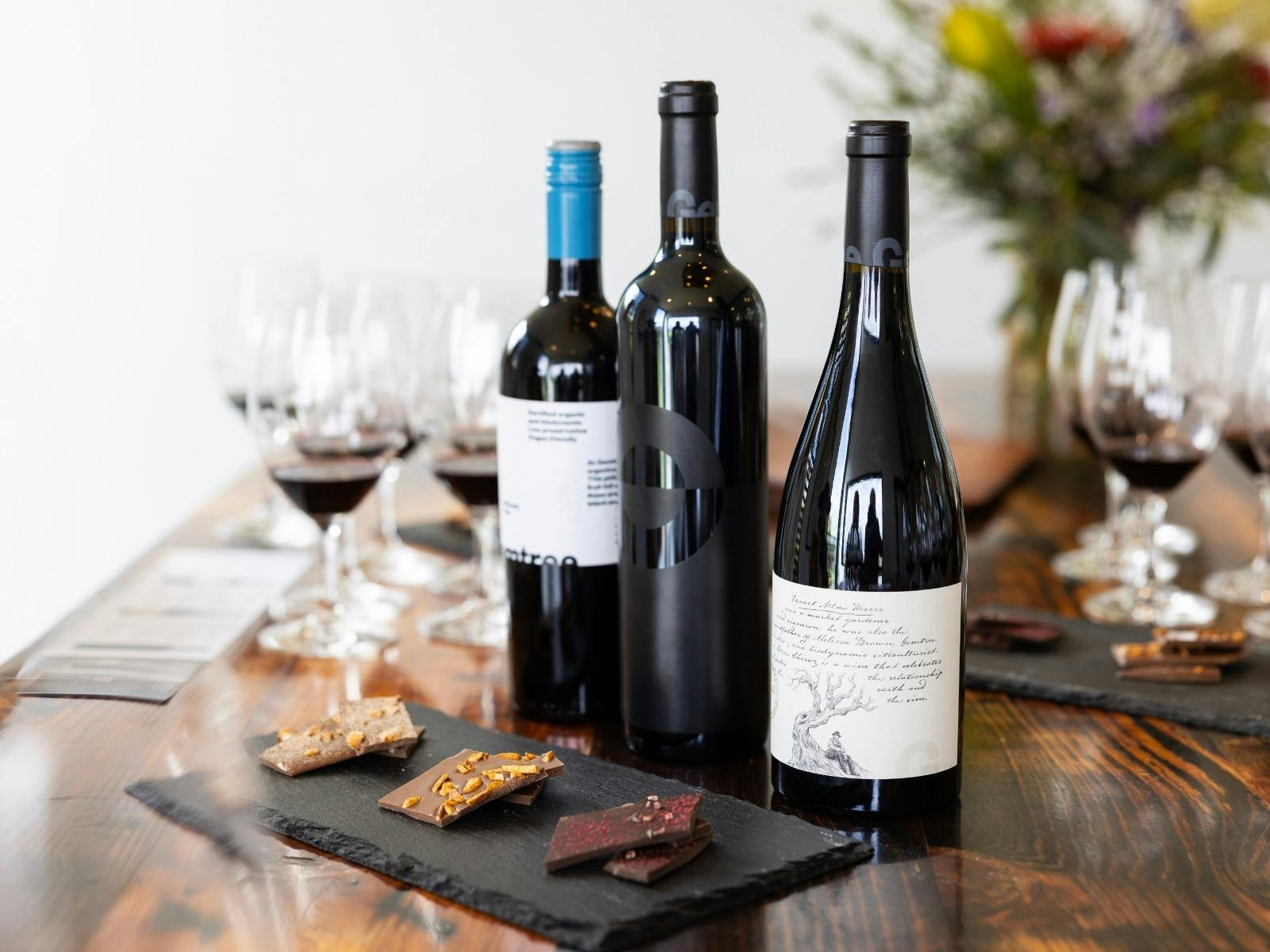 Three bottles of Gemtree Wine with paired chocolates on slate board.