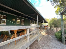 Bunkhouse building exterior with decking, chairs and a table