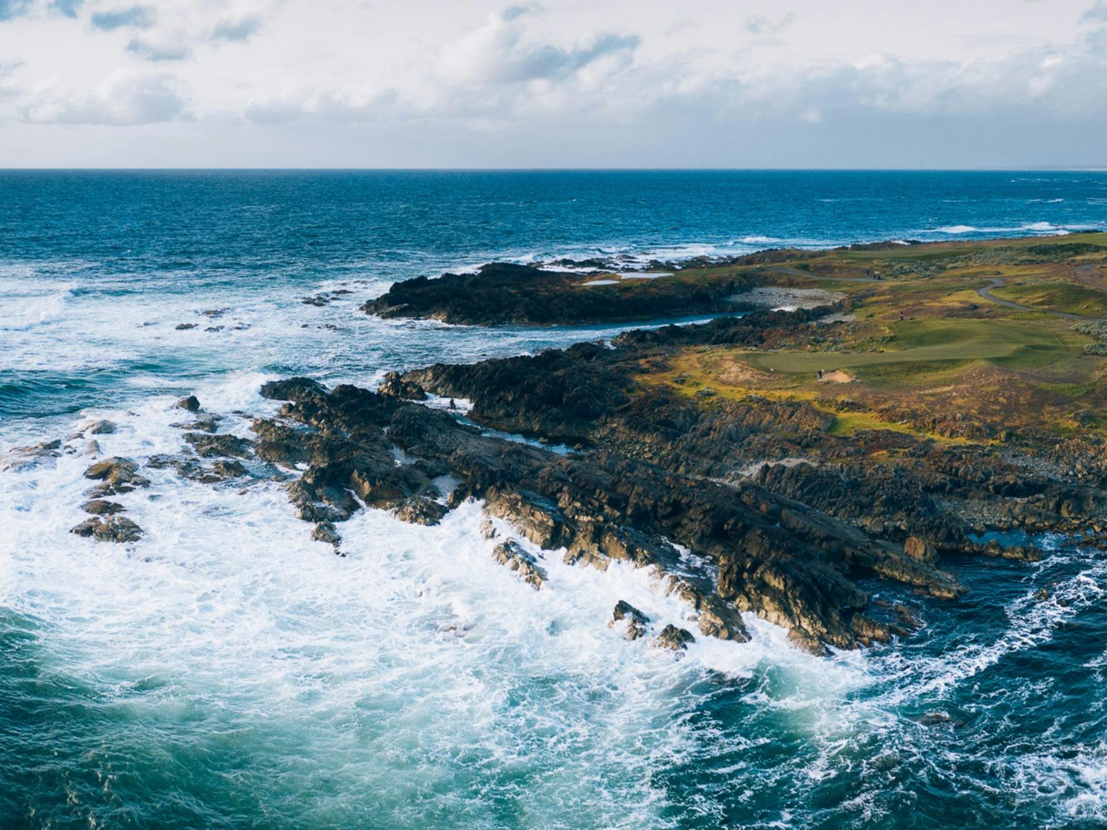 Ocean waves and dramatic cliffside golf hole at Ocean Dunes Golf Course