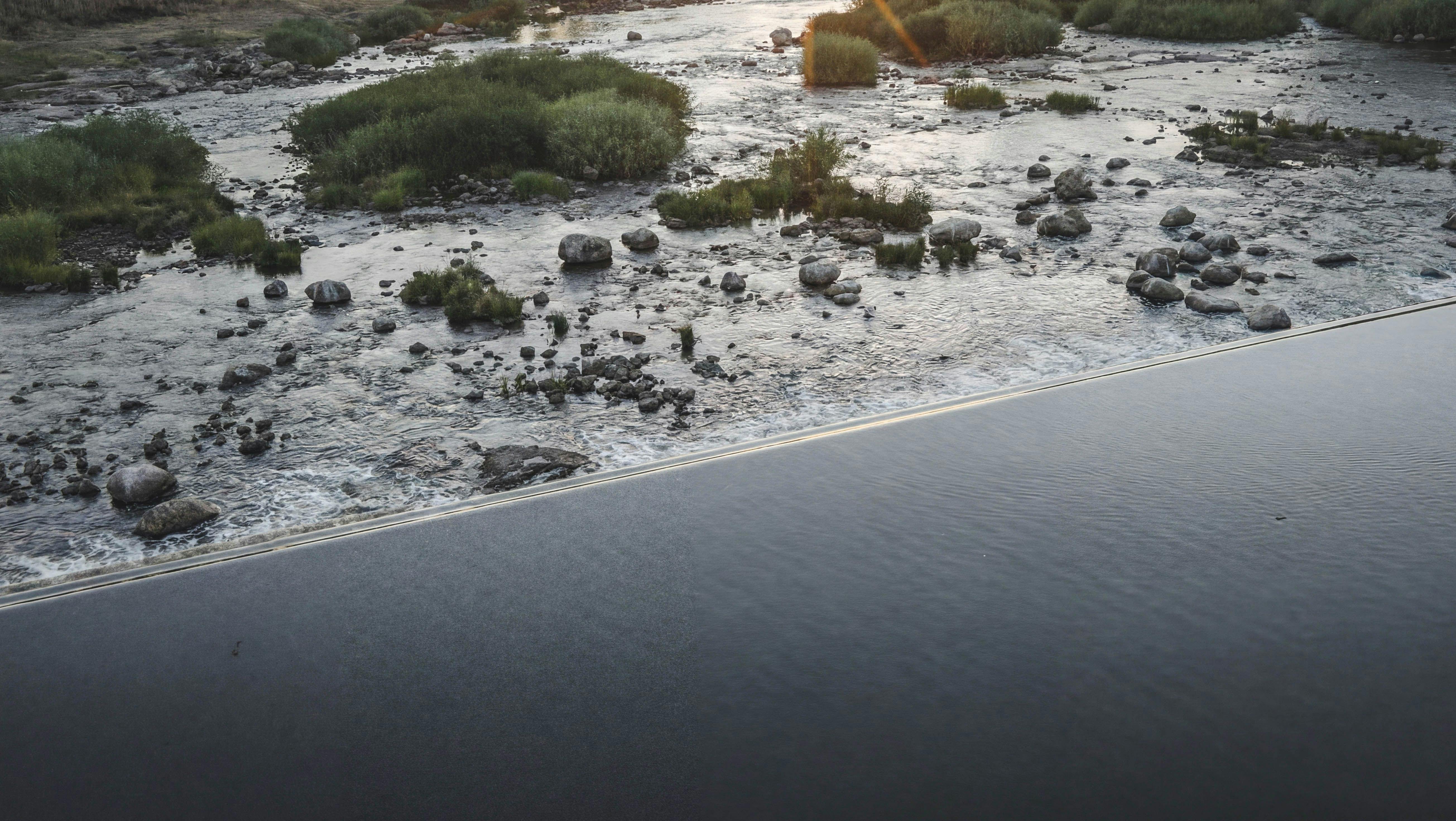 Still image of Brewarrina fish traps and weir on Ngemba Country, from ‘Overflow’ film, 2026. Photo: