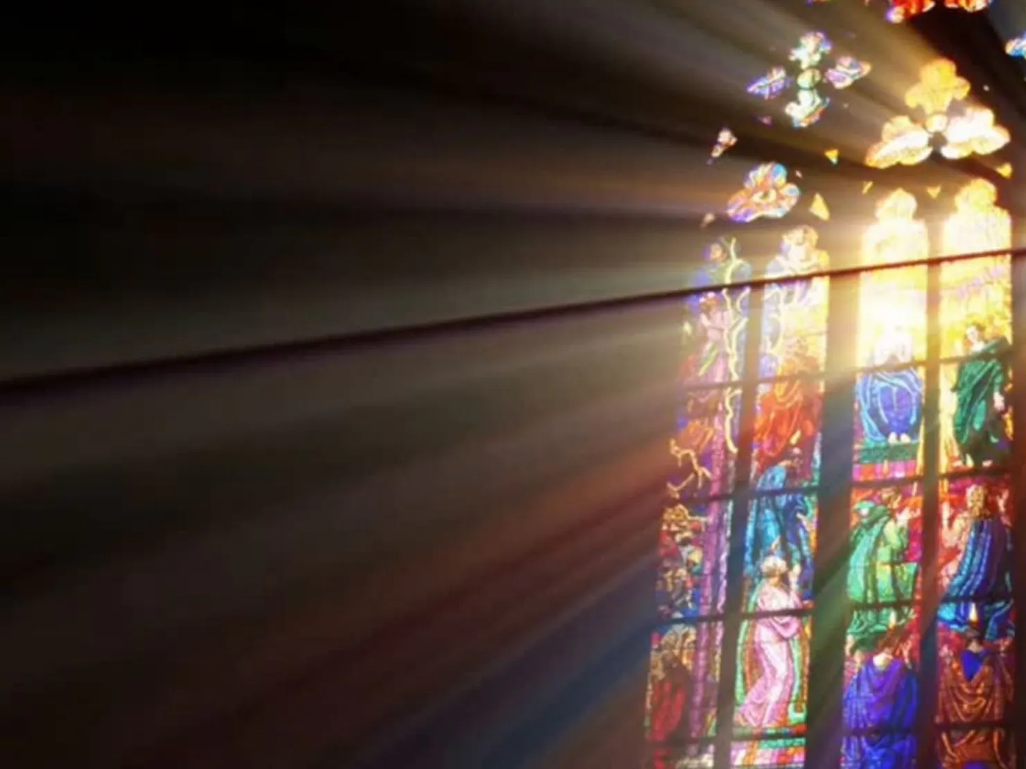 light shining through church stain glass oval window