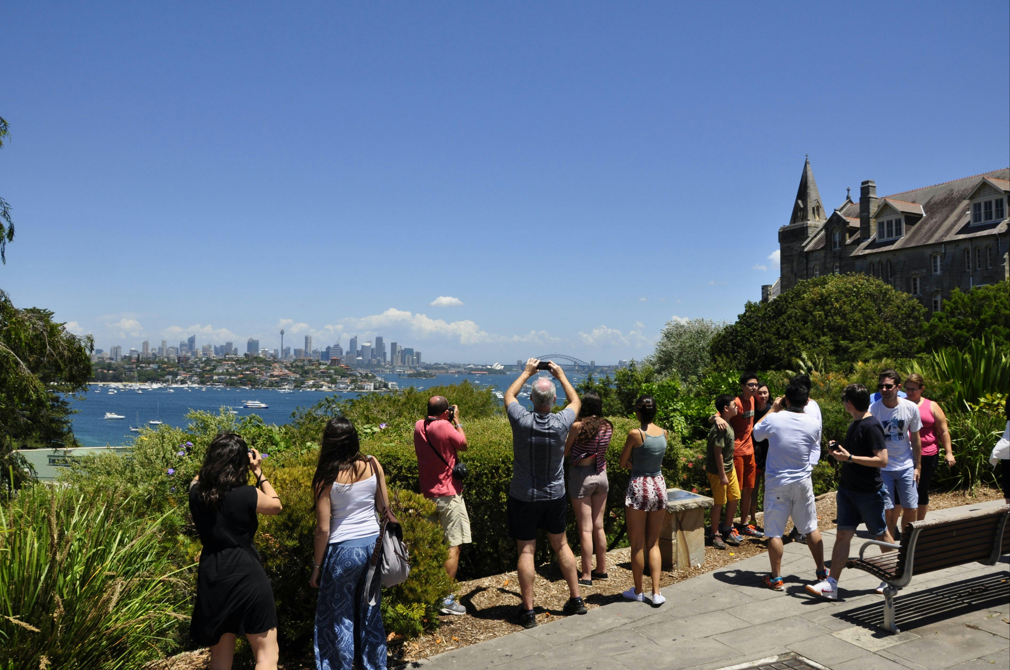 Sydney Sightseeing tour group at another lookout. Visitors are taking pictures of City at a distance