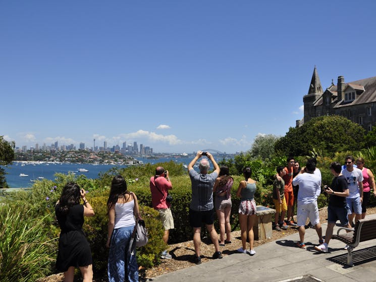 Sydney Sightseeing tour group at another lookout. Visitors are taking pictures of City at a distance