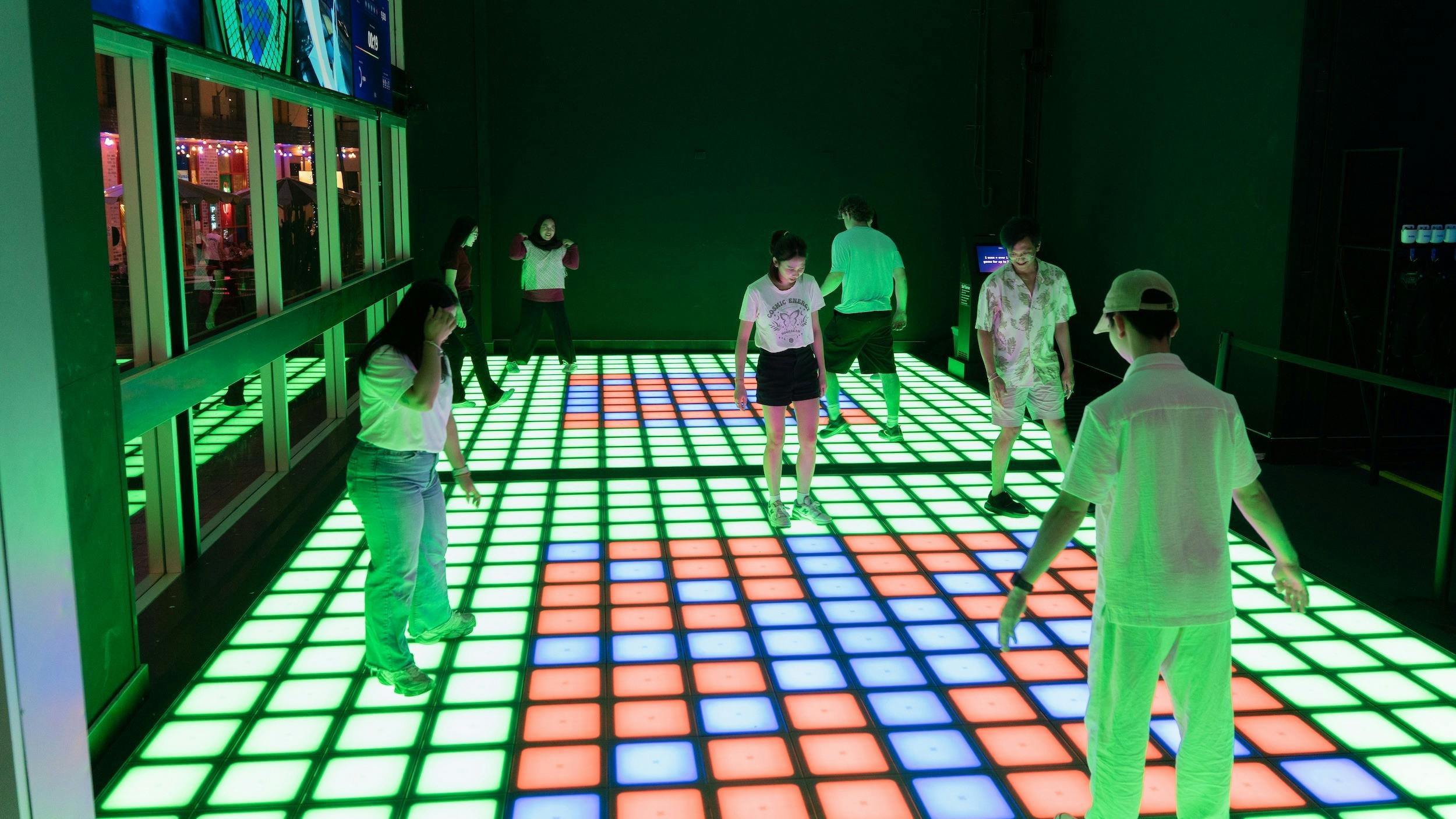 Multiple patrons playing Pixel at night