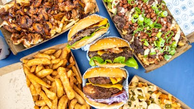 Burgers, fries and drink on a table