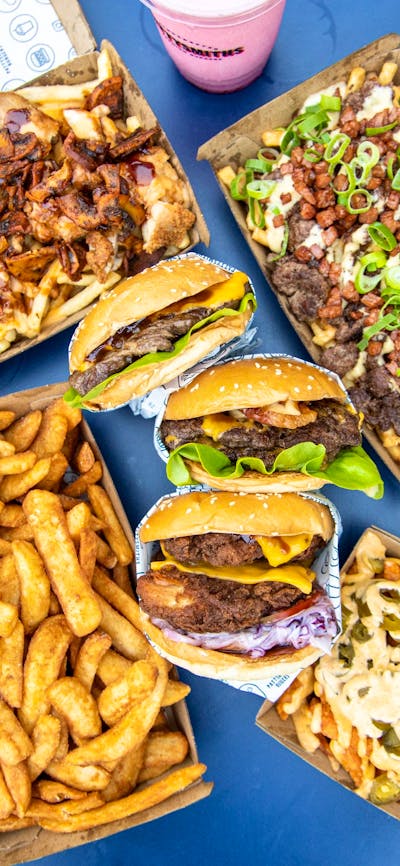Burgers, fries and drink on a table