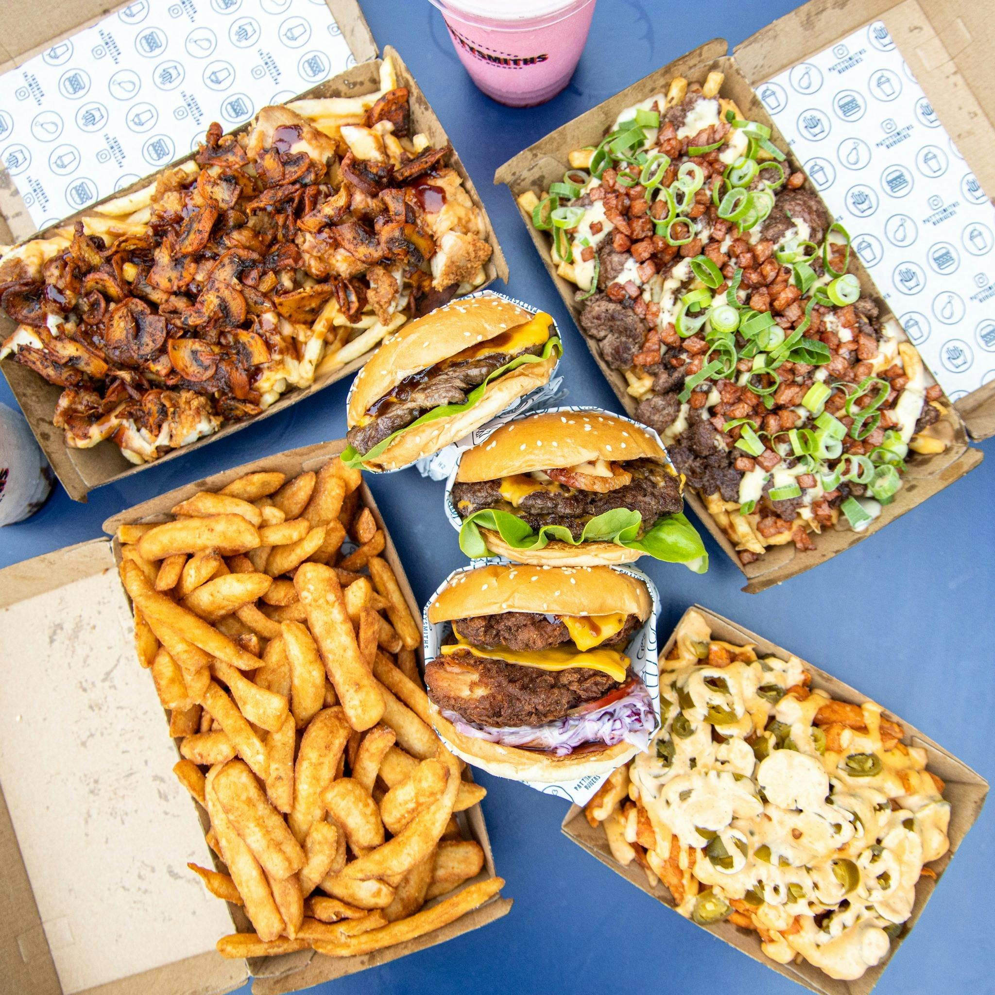 Burgers, fries and drink on a table