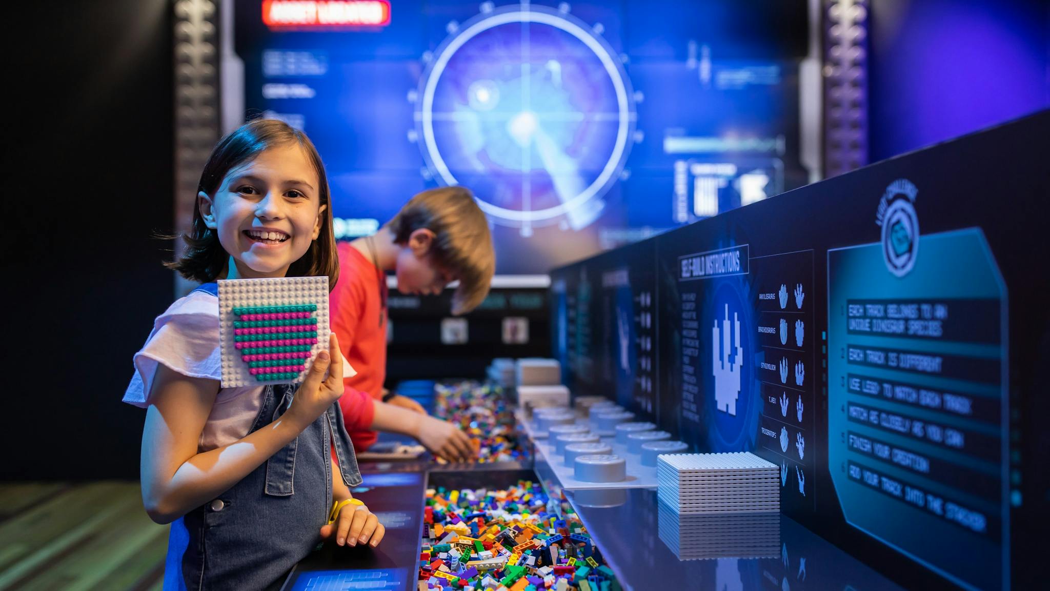 Two children build with LEGO bricks