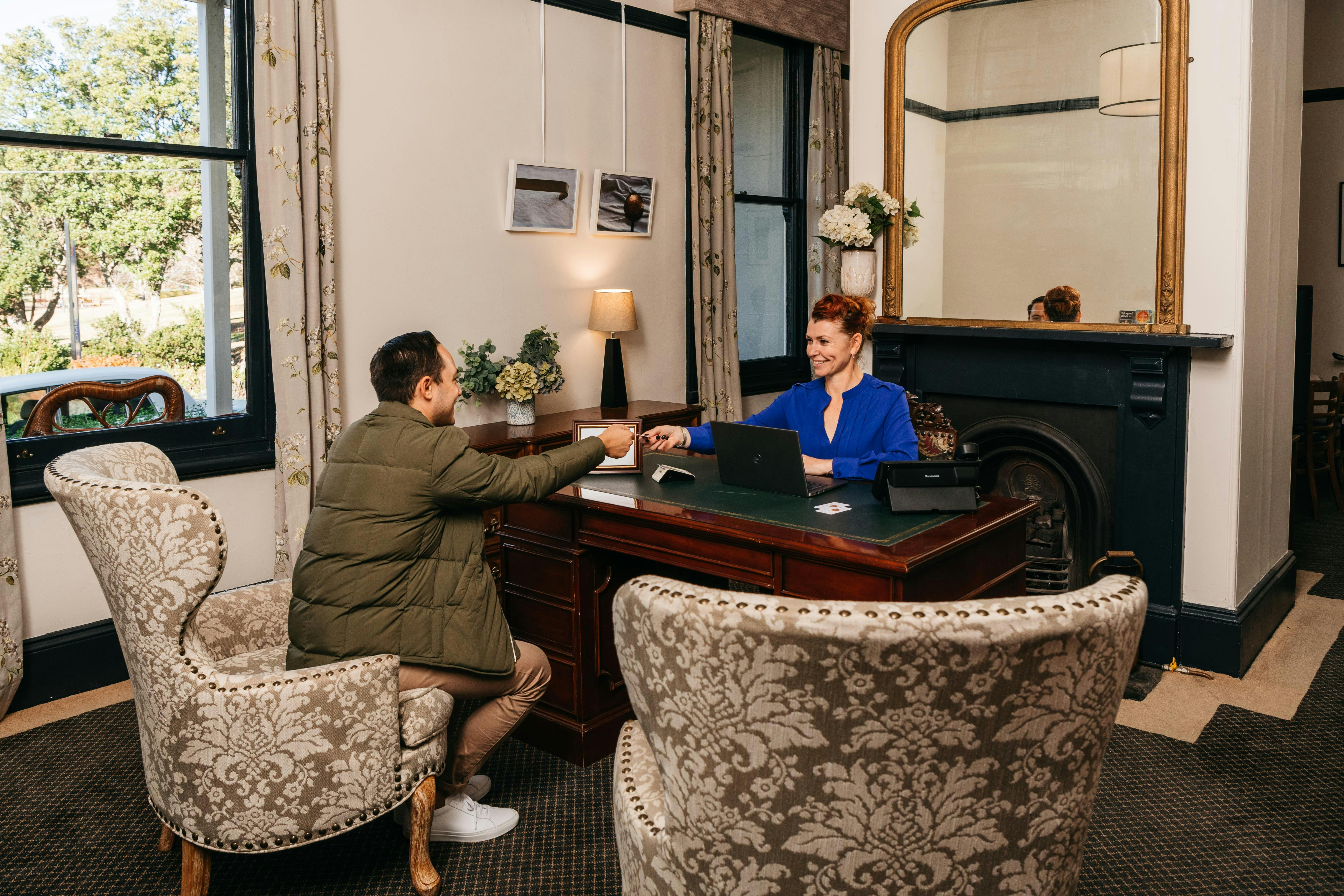 Rceptionist welcoming guest at reception