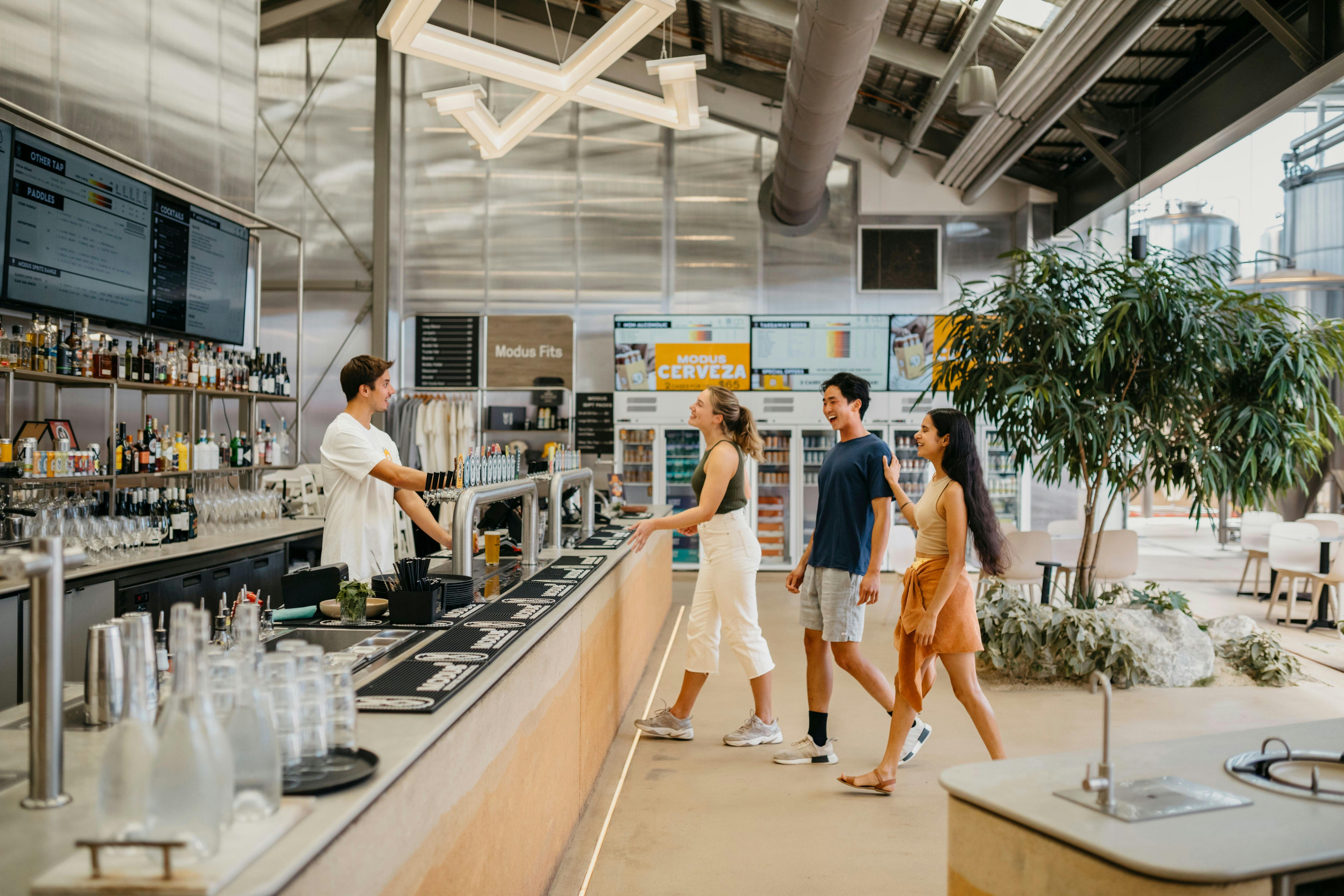 Young people visiting Modus Brewery in Newcastle and enjoying a drink together