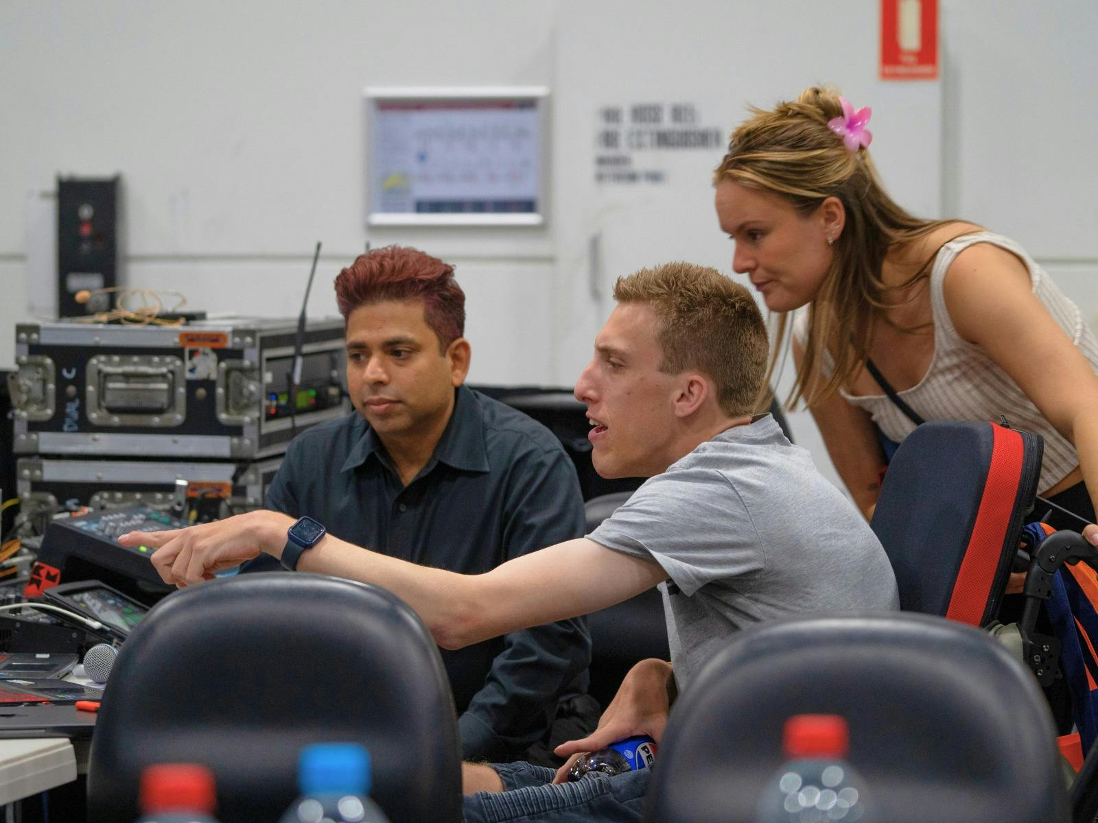 A young man learning about Audio Visual at an Expo