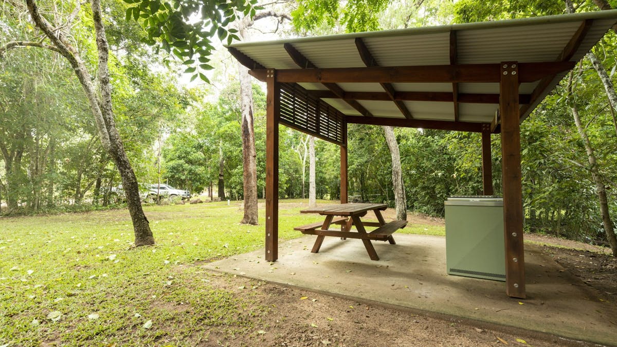 Sheltered picnic table and barbecue.