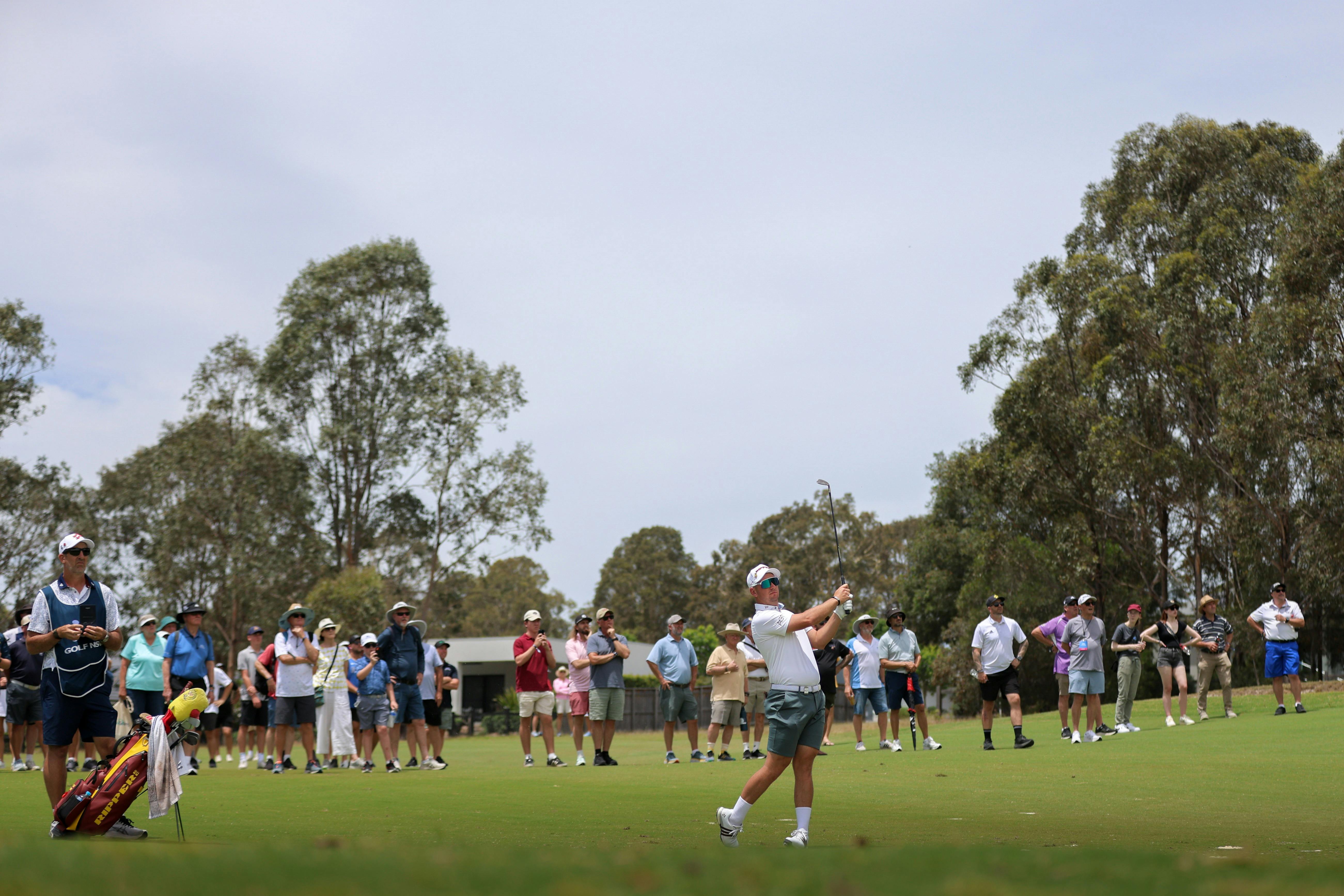 Lucas Herbert on the fairway alongide spectators