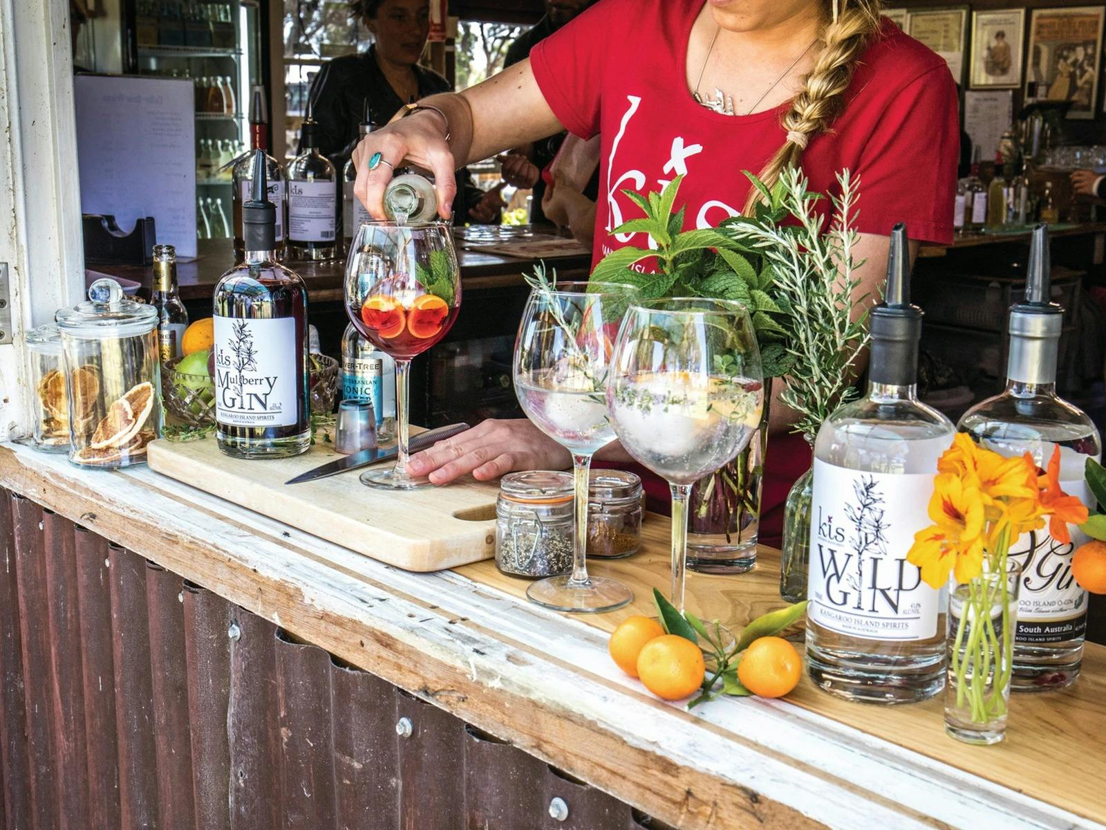 A server pours gin into a tasting glass