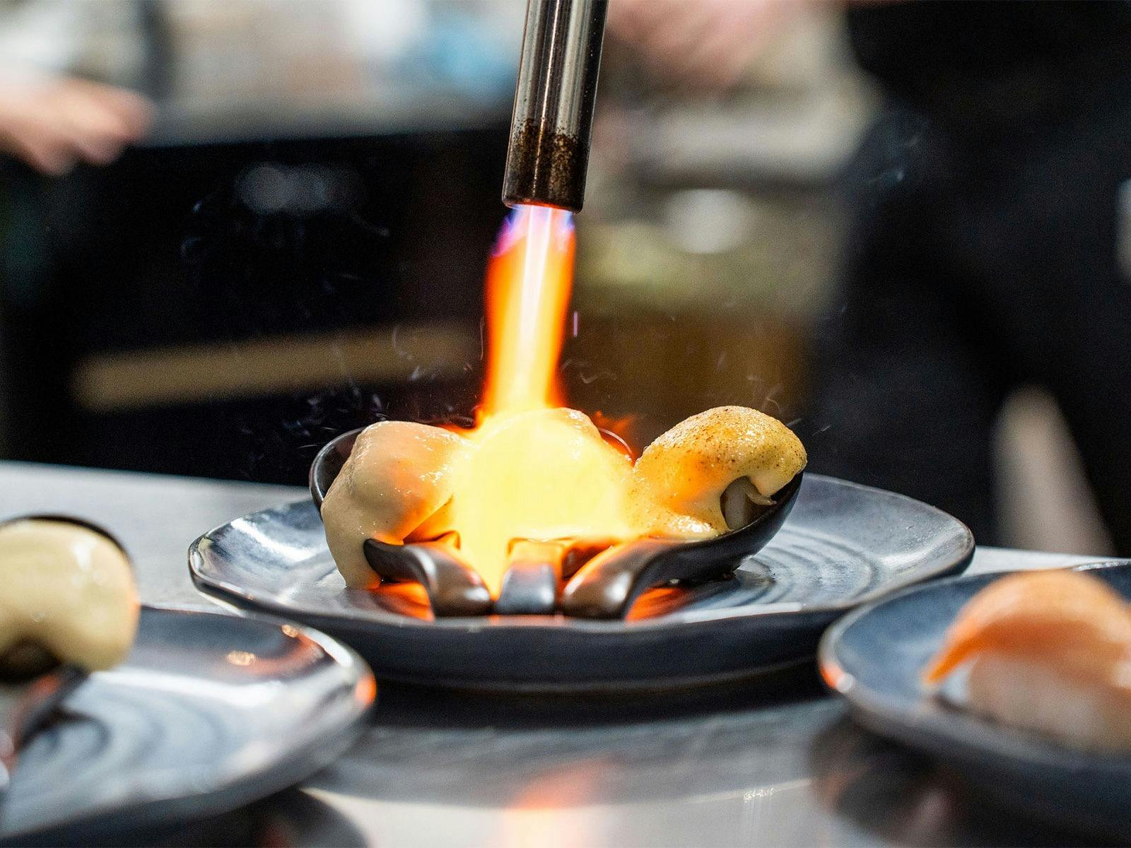 KOI Bar & Restaurant miso brûléed scallops being torched.