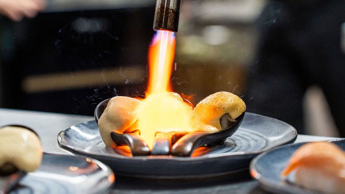 KOI Bar & Restaurant miso brûléed scallops being torched.