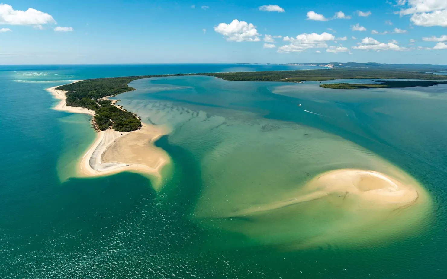 View the amazing colours and shape of Inskip Peninsula, spot the reforming historical sink holes