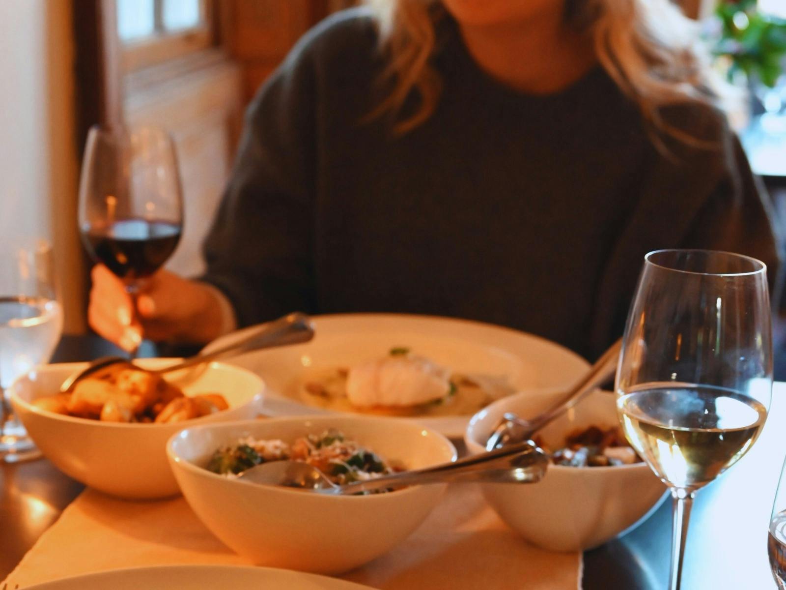 A guest with a selection of hot dishes in front of them ready to eat