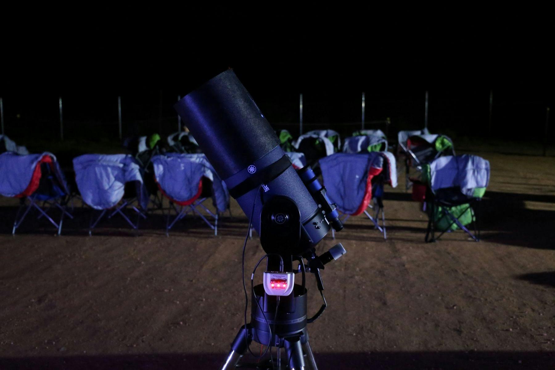 Telescope and chairs set up waiting for people to arrive