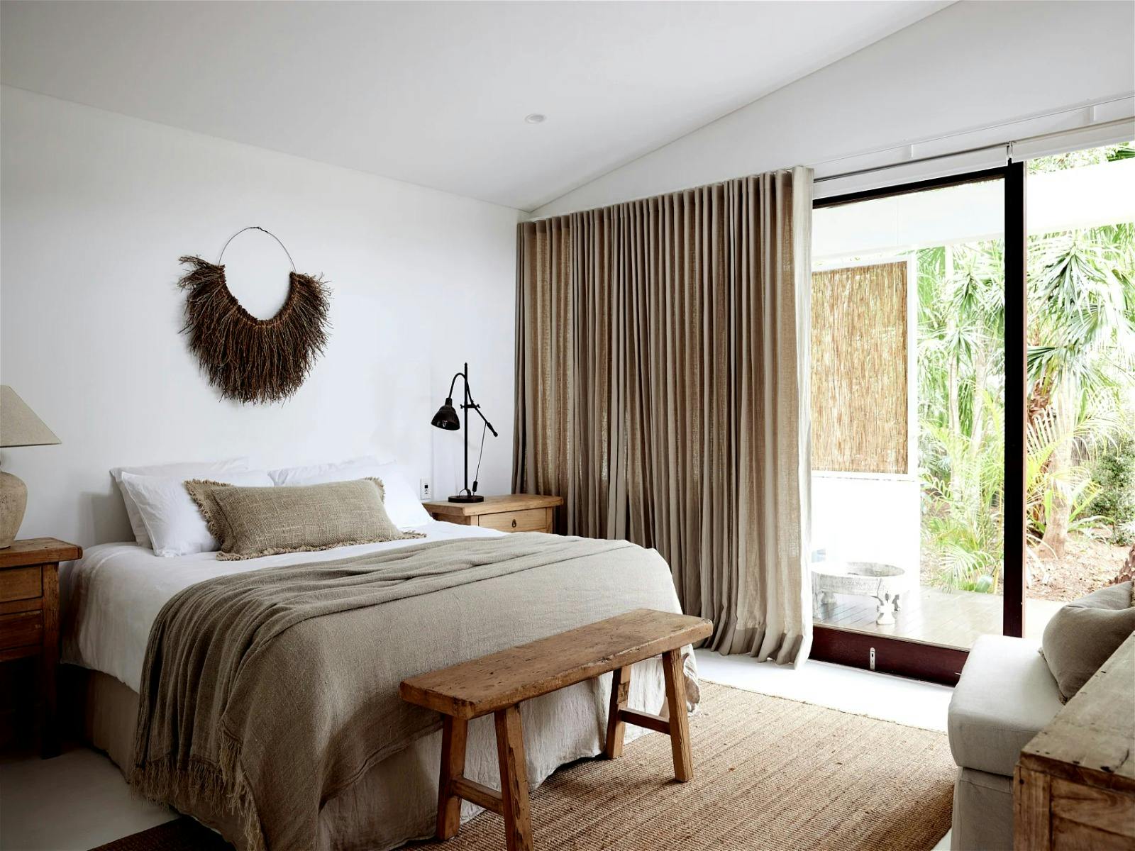 Cozy bedroom with warm lighting and a comfortable queen-size bed