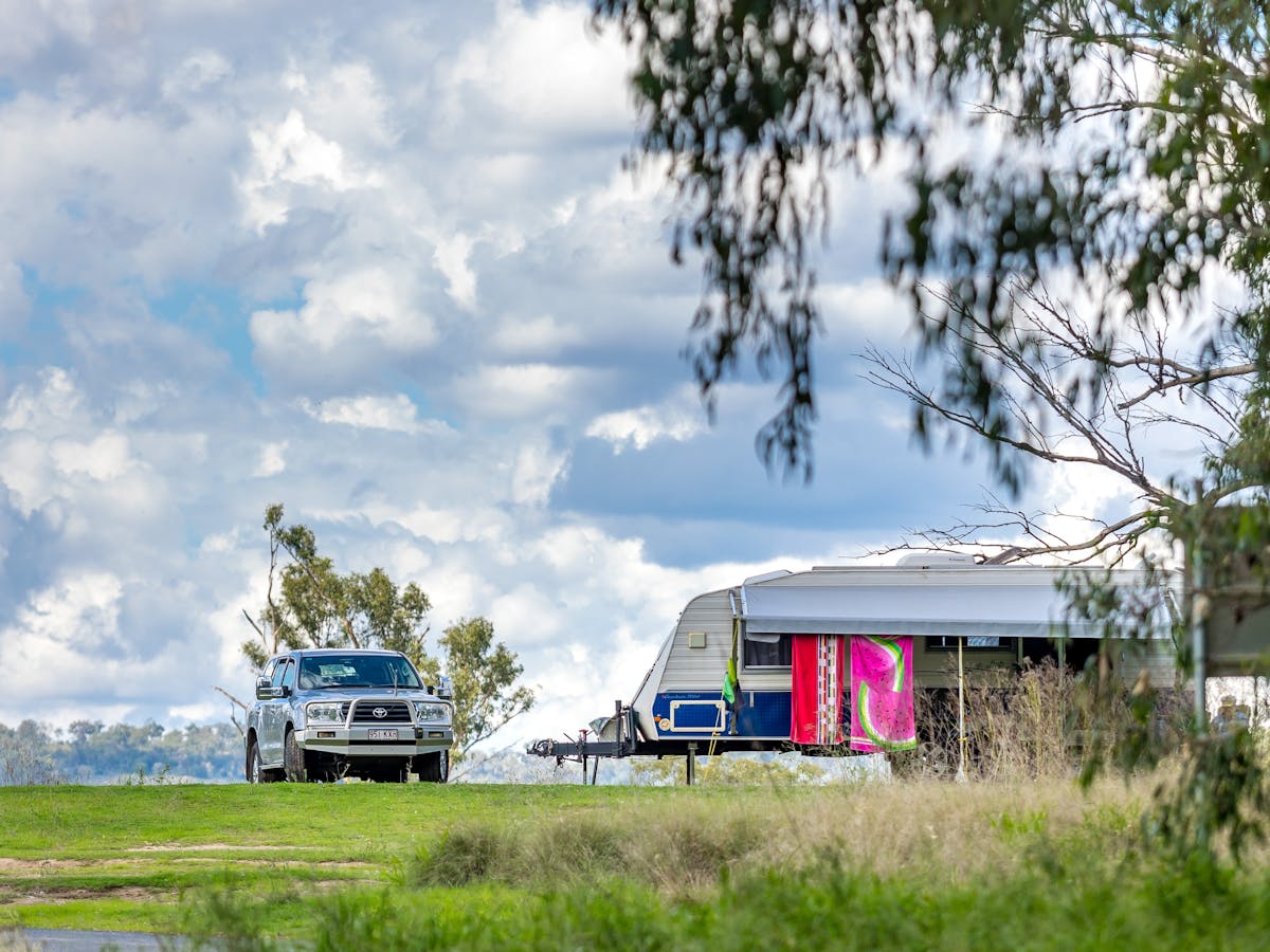 Car and caravan parked at a camping spot Car and caravan parked at a camping spot