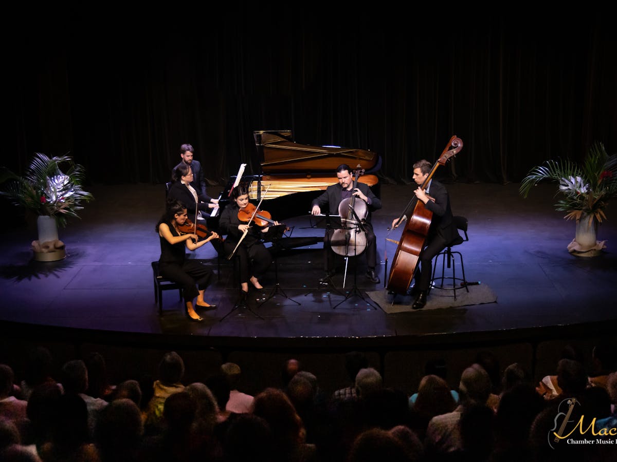 A quintet of musicians performing - violin, viola, piano, cello and double bass A quintet of musicians performing - violin, viola, piano, cello and double bass