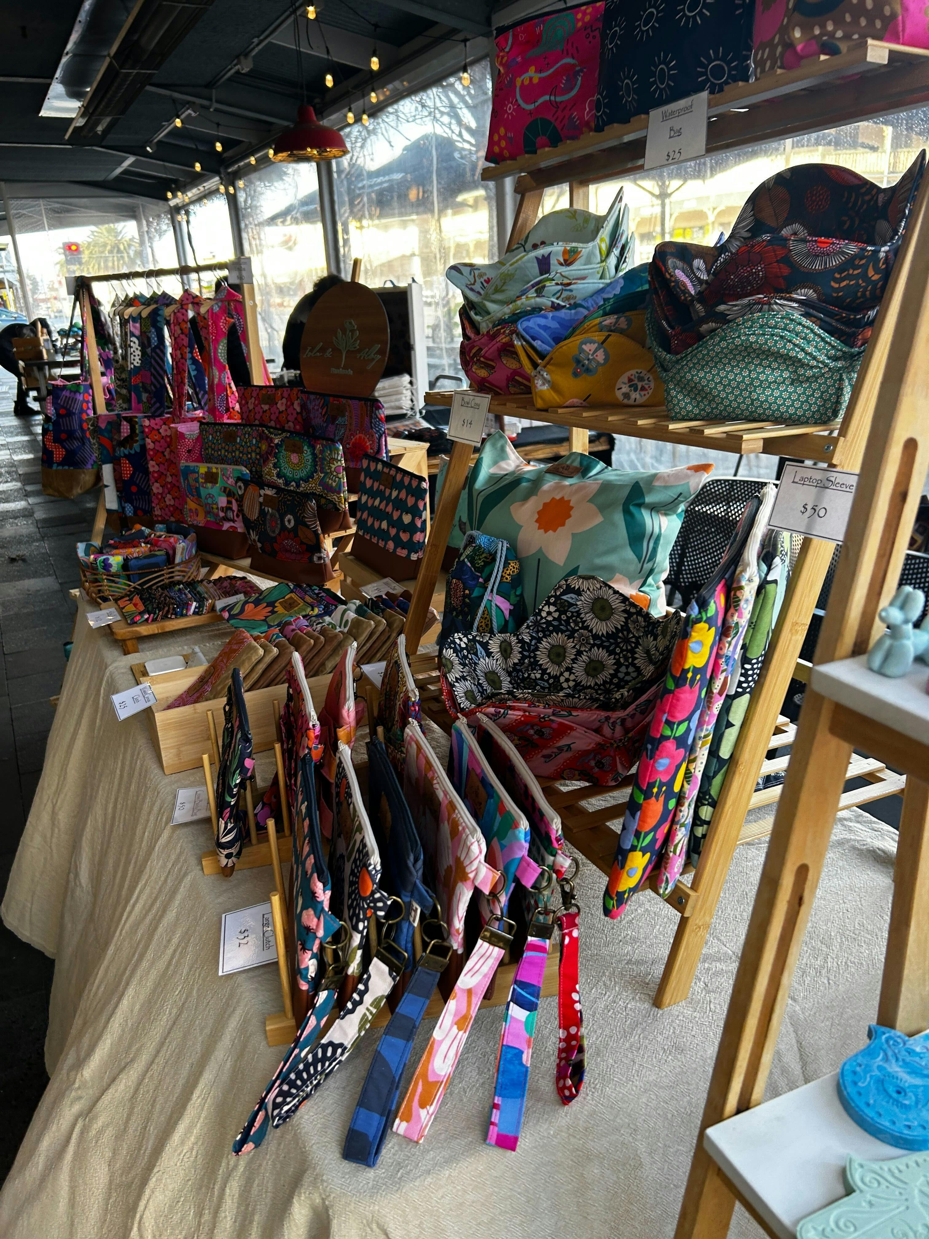 Handmade fabric bags, pouches and accessories displayed at Meandering Markets.
