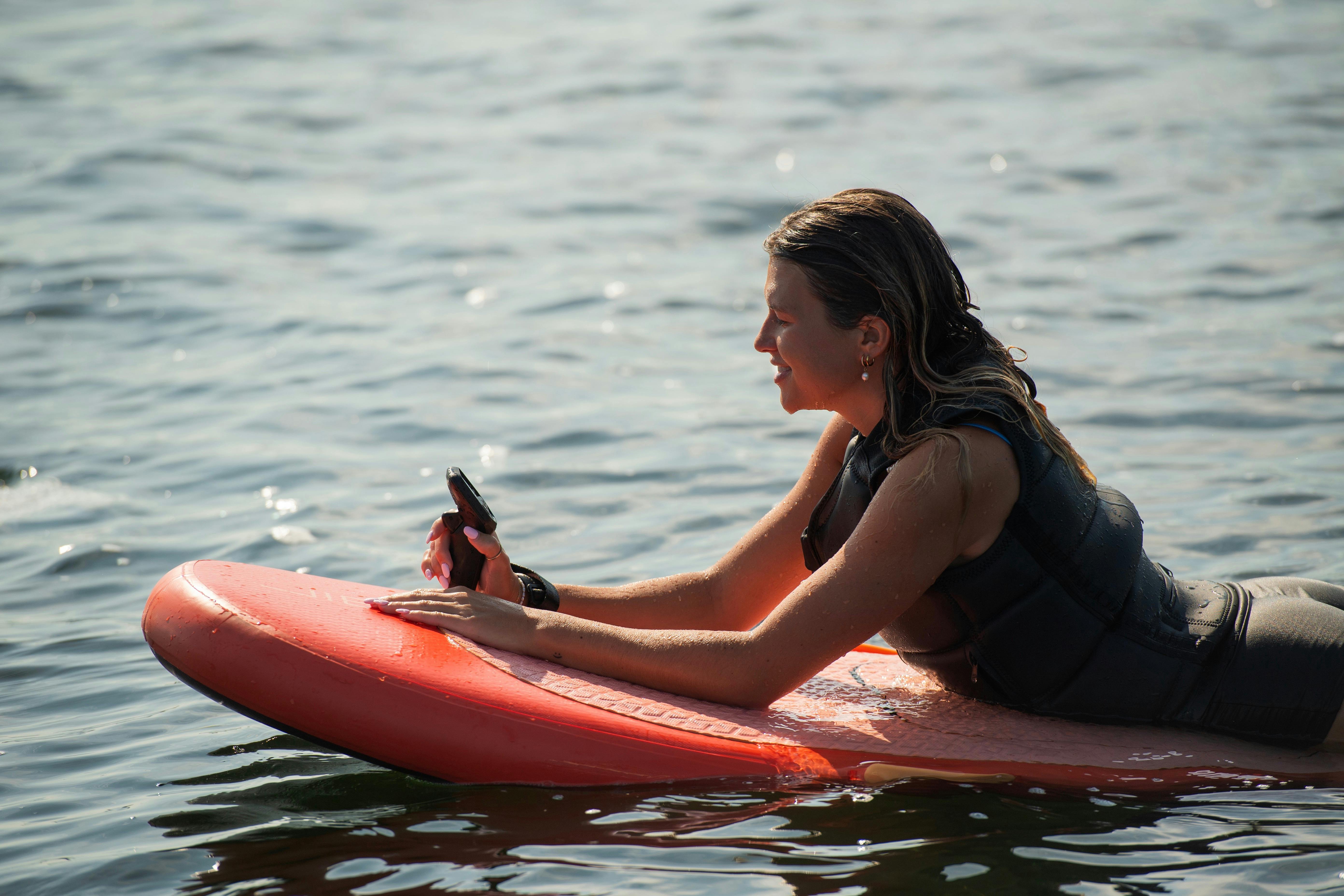 Girl on Fliteboard, learning to foil. Fliteschool Noosa Queensland