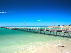The iconic Beachport Jetty extends over the waters of Rivoli Bay.