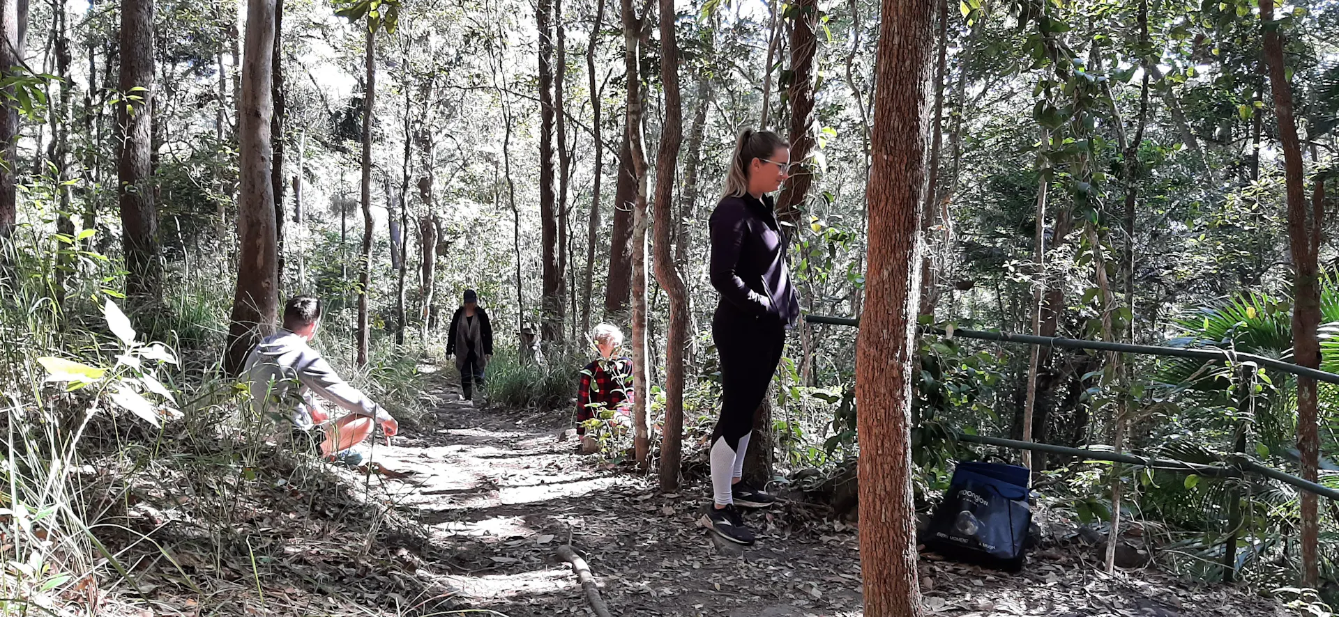 children and adults in bush, open eucalypt forest path