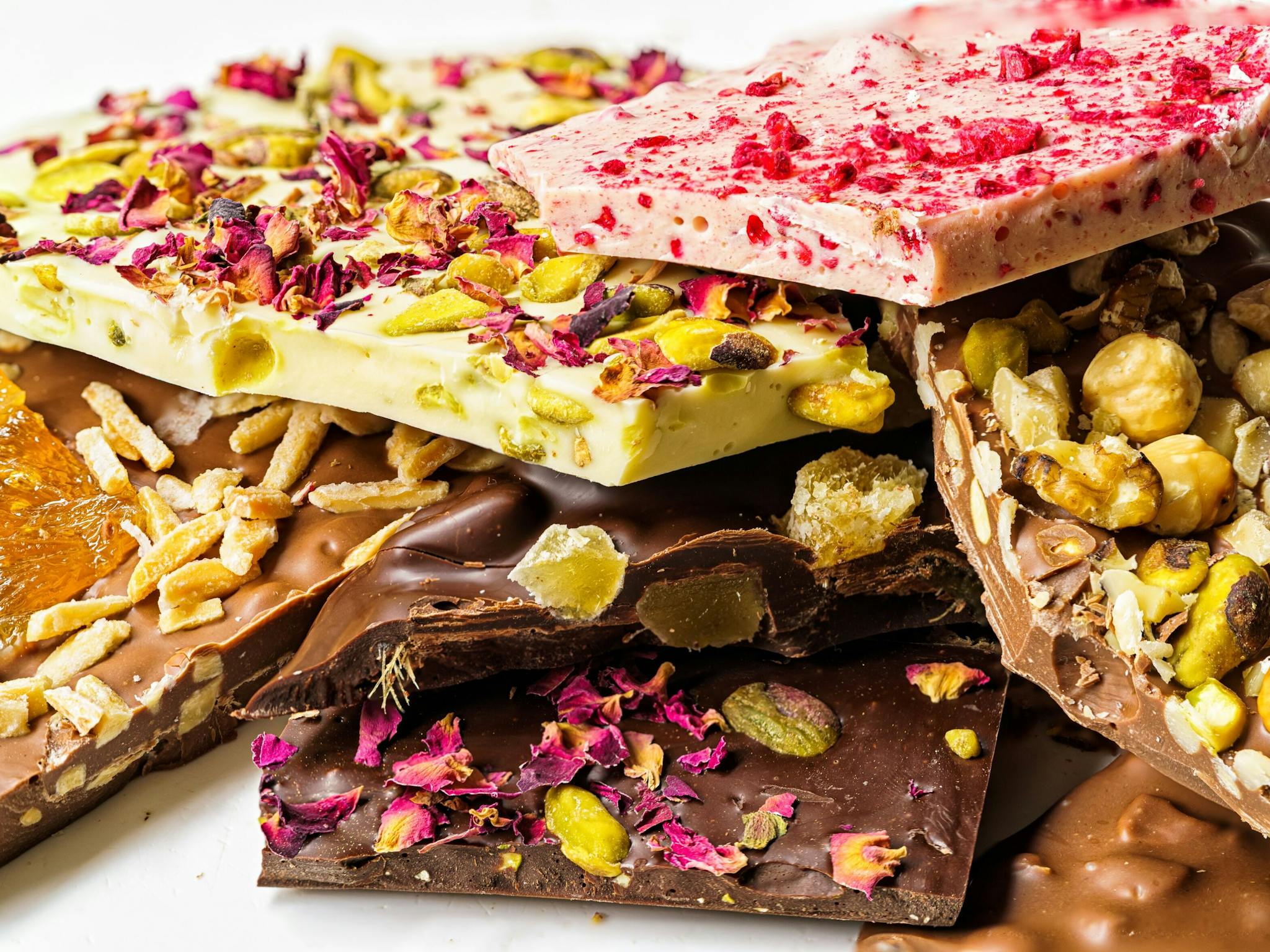 selection of colourful chocolate bars piled on top of each other selection of colourful chocolate bars piled on top of each other