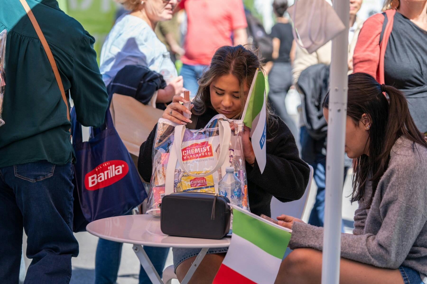 Visitors enjoy the vibrant outdoor atmosphere of the Italian Festa & Expo.
