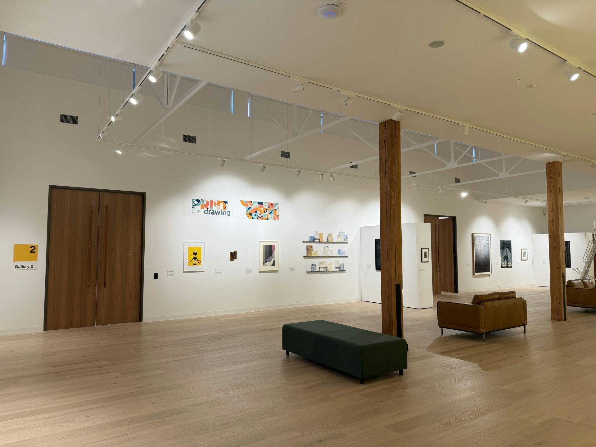 An interior photo of the gallery, with artworks on the wall,