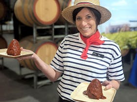 woman holds plate of Arancini balls